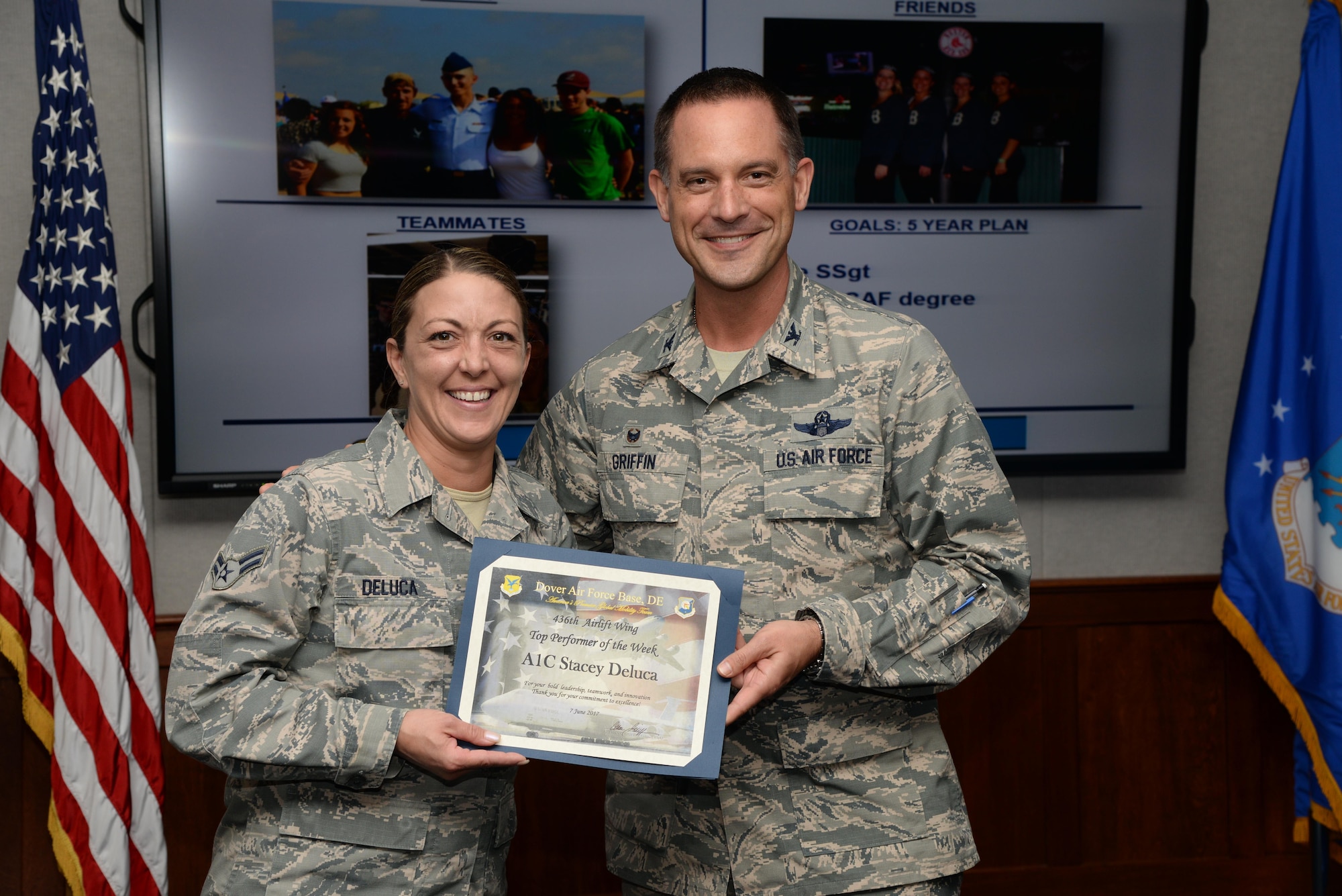 Col. Ethan Griffin, 436th Airlift Wing commander, presents the Top Performer of the Week award to Airman 1st Class Stacey Deluca, 436th Maintenance Squadron Regional Isochronal Inspection Dock consolidated tool krib custodian, during the weekly wing stand up meeting June 7, 2017, at Dover Air Force Base, Del. Deluca was recognized for her outstanding performance above and beyond that expected of an airman first class. (U.S. Air Force photo by Senior Airman Aaron J. Jenne)