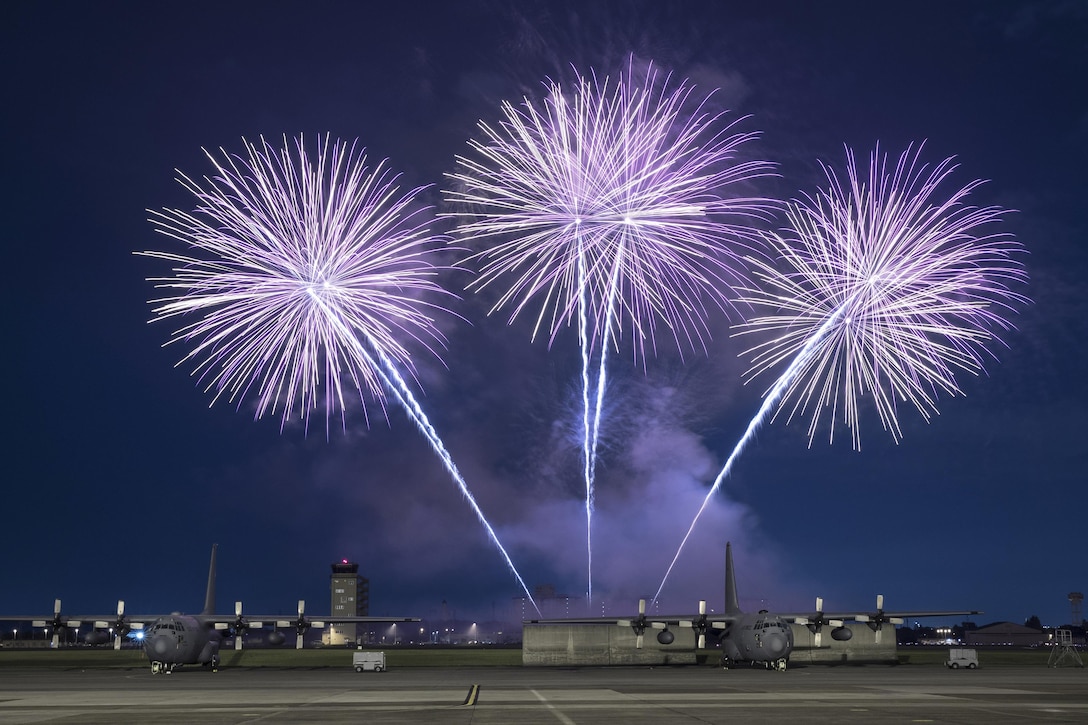 Fireworks explode behind Air Force C-130 Hercules aircraft at Yokota Air Base, Japan, June 30, 2017, during the base's annual Celebrate America event. Air Force photo by Yasuo Osakabe
