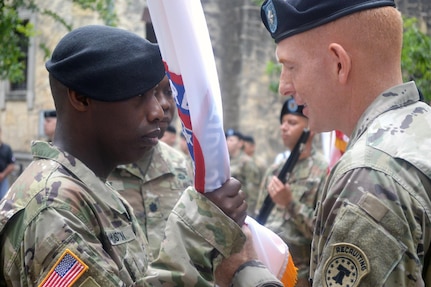 Col. Terance L. Huston (left), U.S. Army 5th Recruiting Brigade commander, takes the guidon from Lt. Col. Kevin D. Bouren (right), the San Antonio Recruiting Battalion outgoing commander.