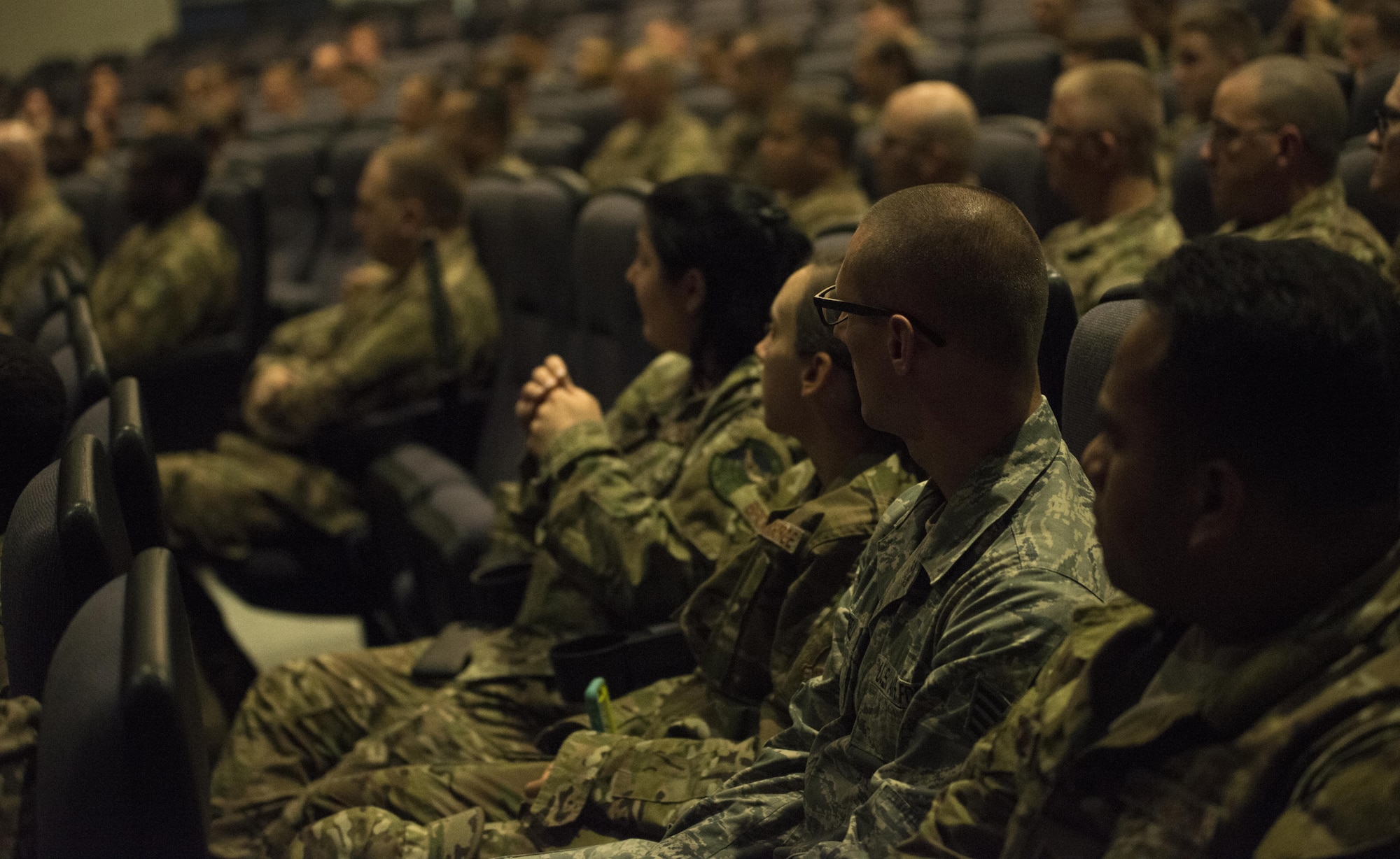 Enlisted members of the 353rd Special Operations Group listen to Air Force Special Operations Command Chief Master Sgt. Gregory Smith during an all-call June 19, 2017 at Kadena Air Base, Okinawa, Japan. Smith described the significance of these changes, provided resources and emphasized the choices Airmen need to make. (U.S. Air Force photo by Capt. Jessica Tait)