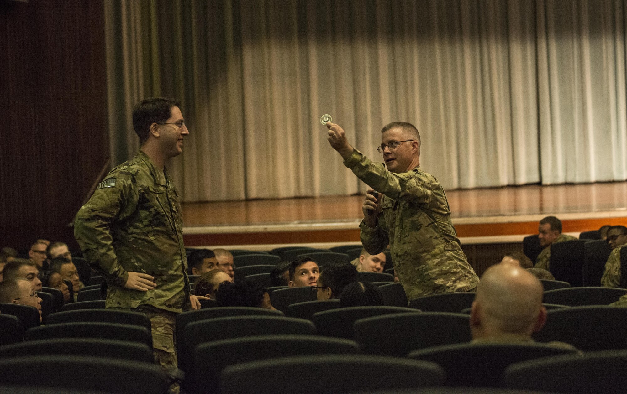 Air Force Special Operations Command Chief Master Sgt. Gregory Smith gives a coin to a 353rd Special Operation Support Squadron Airmen during an all-call June 19, 2017 at Kadena Air Base, Okinawa, Japan. The AFSOC command chief praised the enlisted members who enable SOF operations across the entire Pacific. (U.S. Air Force photo by Capt. Jessica Tait)