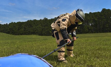 Staff Sgt. Eric Jones, 628th Civil Engineer Squadron explosive ordnance disposal technician, reaches for an ordinance during training exercise Mogul Wrath, June 27, 2017. EOD trains consistently to sharpen their skills and readiness. 