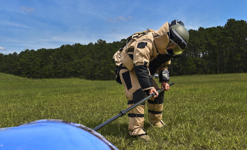 Staff Sgt. Eric Jones, 628th Civil Engineer Squadron explosive ordnance disposal technician, reaches for an ordinance during training exercise Mogul Wrath, June 27, 2017. EOD trains consistently to sharpen their skills and readiness. 