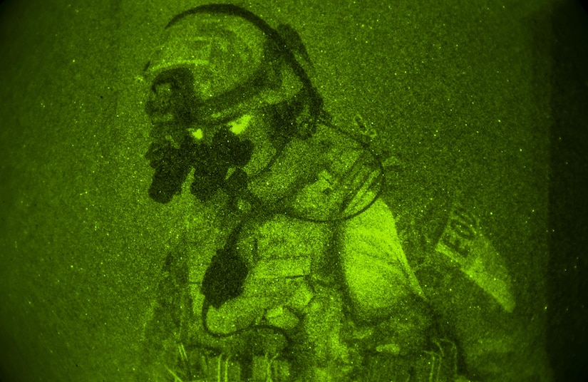 Staff Sgt. Eric Jones, 628th Civil Engineer Squadron explosive ordnance disposal technician, listens for instructions from his teammate during a training exercise, June 29, 2017. The training operation incorporated nighttime operations, wartime expedient chemical munition procedures and tactical vehicle operations. 