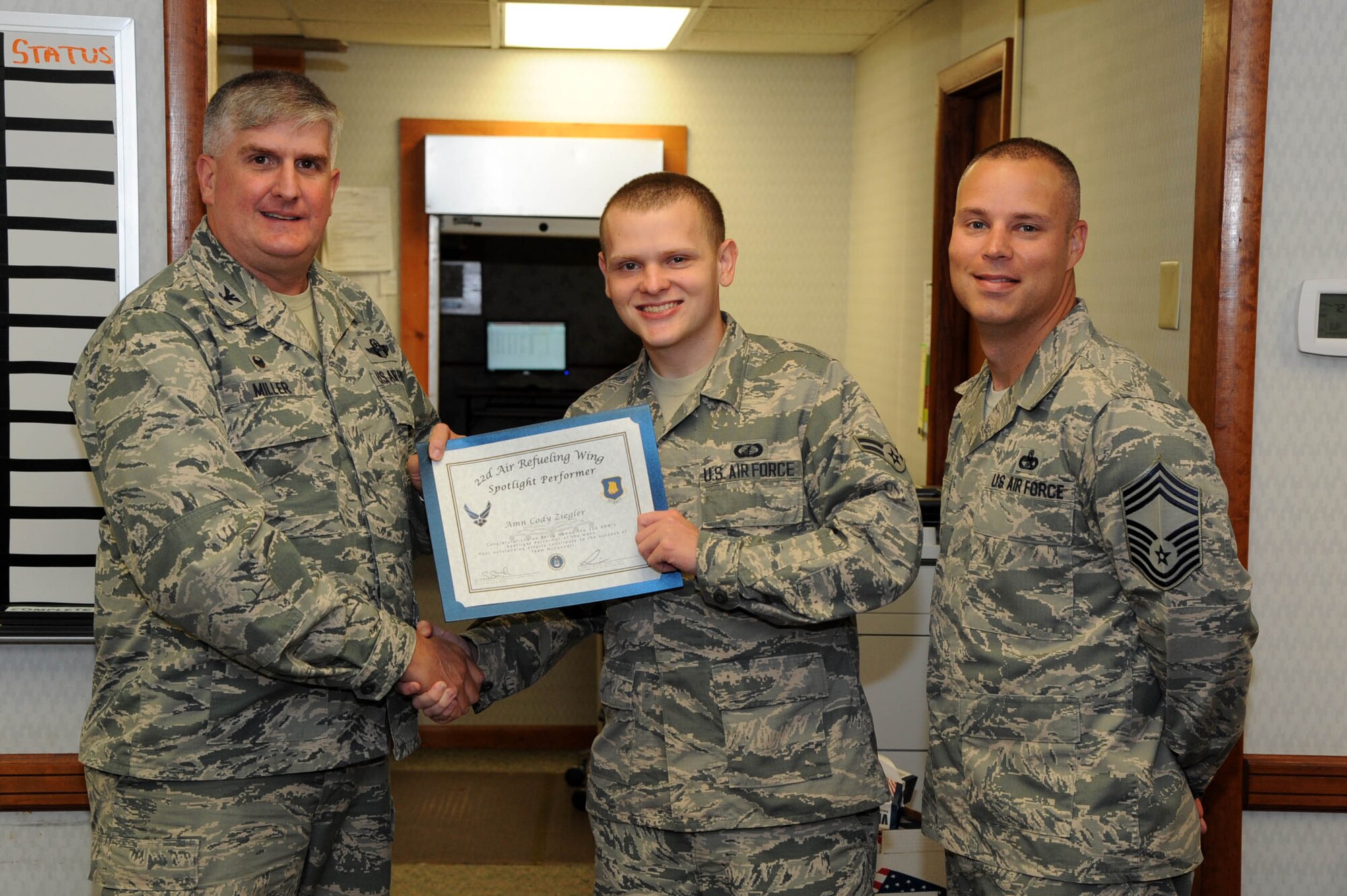 Airman 1st Class Cody Ziegler, 22nd Comptroller Squadron financial services technician, poses with Col. Albert Miller, 22nd Air Refueling Wing commander, and Chief Master Sgt. Sean Smith, 22nd Mission Support Group Superintendent, June 29, 2017, at McConnell Air Force Base, Kan. Ziegler received the spotlight performer for the week of June 5-9. (U.S. Air Force photo/Senior Airman Jenna K. Caldwell) 
