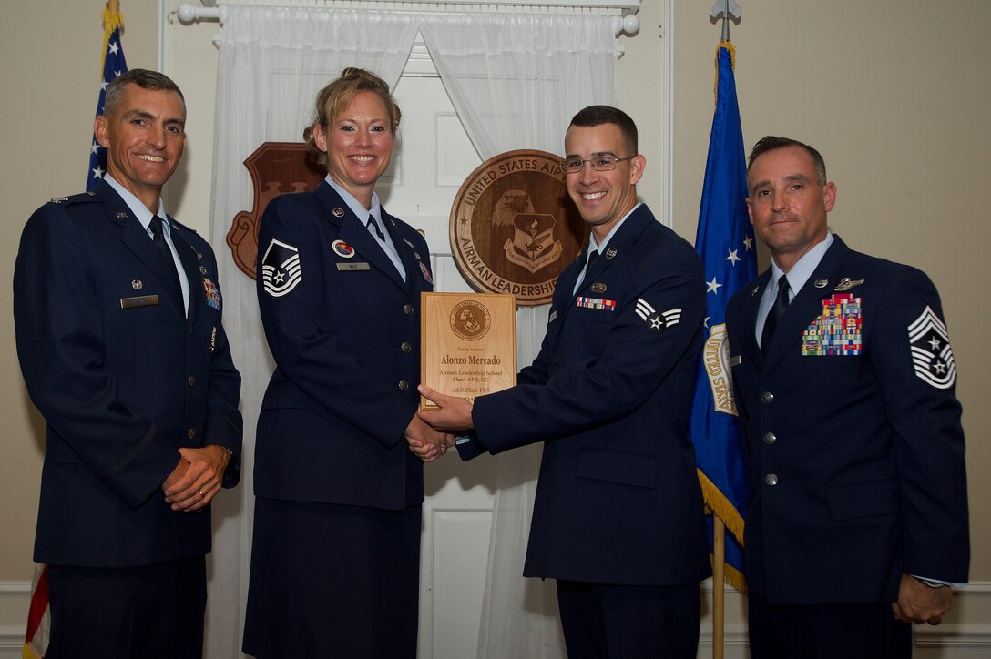 U.S. Air Force Senior Airman Alonzo Mercado, 3rd Intelligence Squadron, receives the Commandant Award during the Senior Master Sgt. David B. Reid Airman Leadership School Class 17-5 graduation ceremony at Shaw Air Force Base, S.C., June 30, 2017. The Commandant’s award is given to the student who most exemplifies professional military qualities and is chosen by their peers, their primary instructors, and the ALS commandant. (U.S. Air Force photo by Senior Airman Michael Cossaboom)