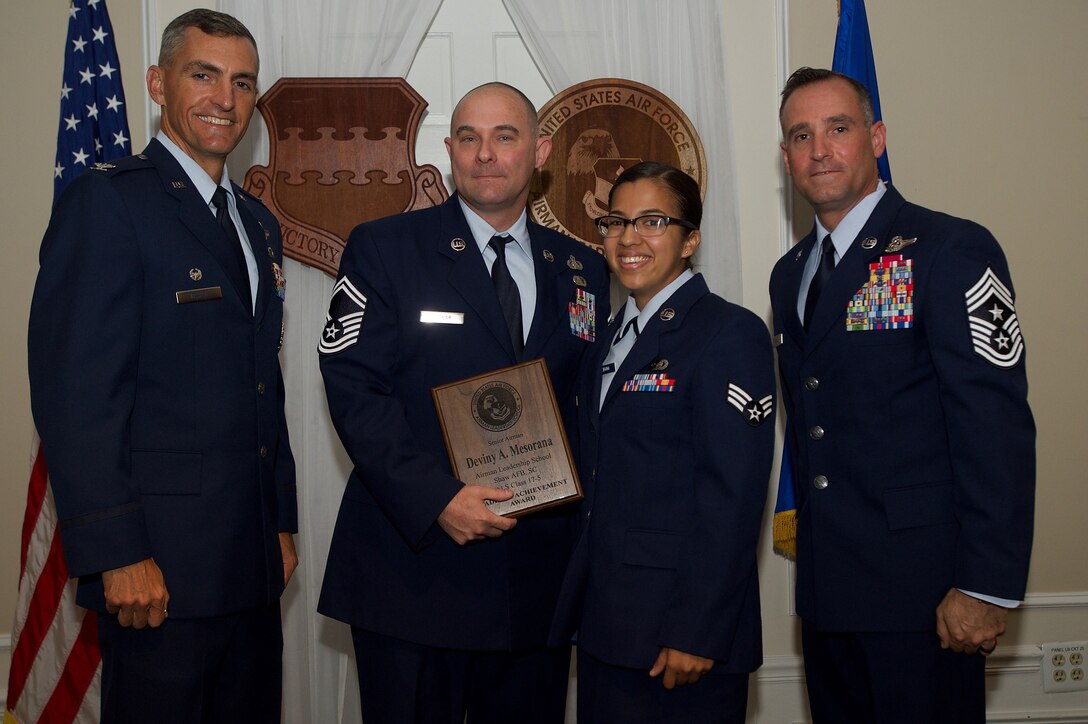 U.S. Air Force Senior Airman Deviny Mesorana, 31st Intelligence Squadron, receives the Academic Achievement Award during the Senior Master Sgt. David B. Reid Airman Leadership School Class 17-5 graduation ceremony at Shaw Air Force Base, S.C., June 30, 2017. This award is given to the student with the highest point total. (U.S. Air Force photo by Senior Airman Michael Cossaboom)
