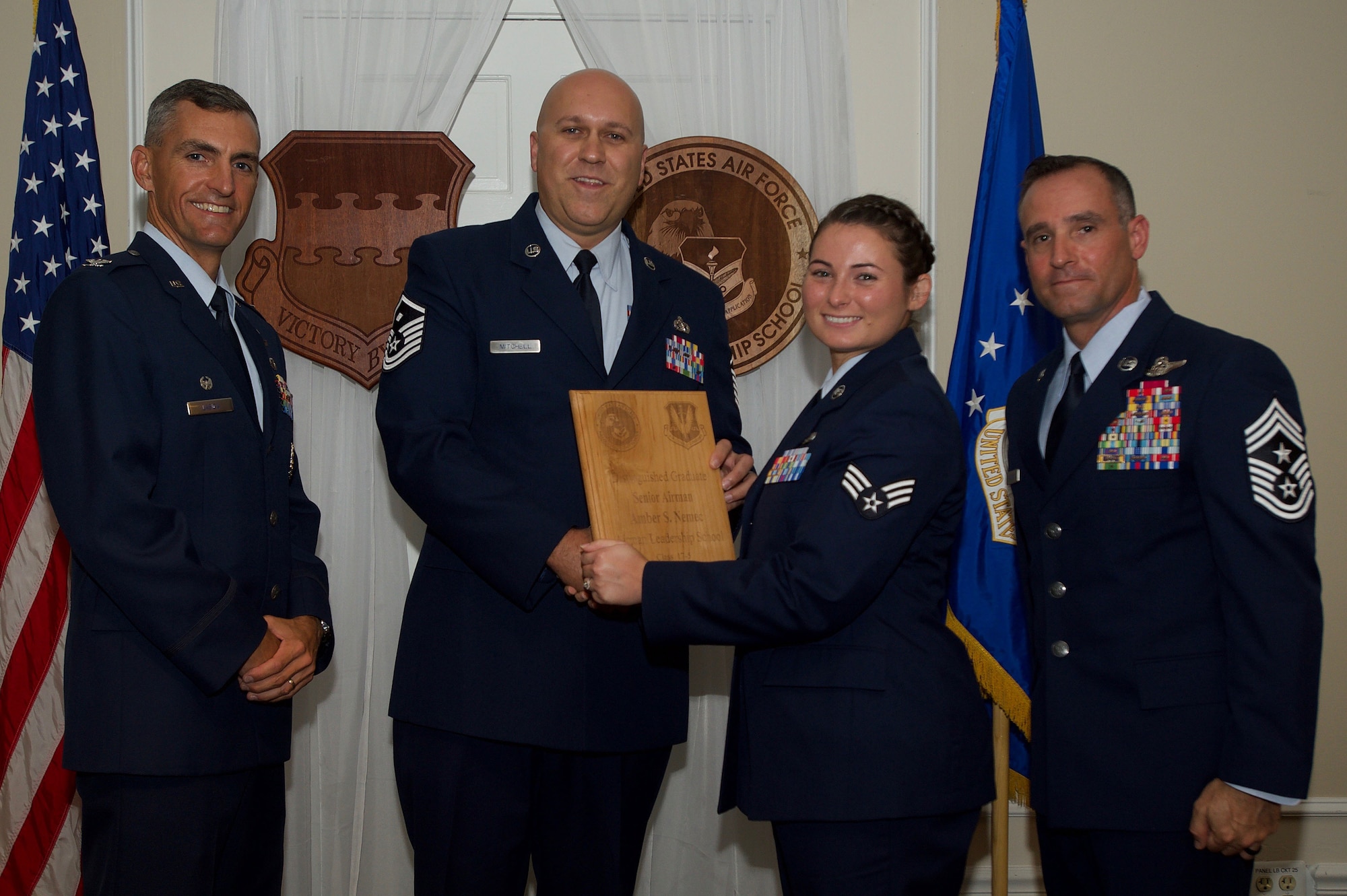 U.S. Air Force Senior Airman Amber Nemec, 367th Fighter Squadron, receives a Distinguished Gradate Award during the Senior Master Sgt. David B. Reid Airman Leadership School Class 17-5 graduation ceremony at Shaw Air Force Base, S.C., June 30, 2017. Distinguished graduate awards are given to the top 10 percent of the class for total point accumulation. (U.S. Air Force photo by Senior Airman Michael Cossaboom)