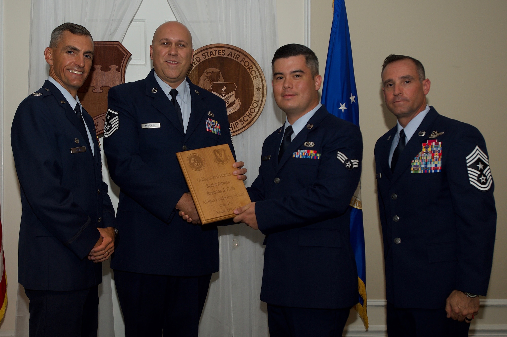 U.S. Air Force Senior Airman Brandon Celis, 315th Fighter Squadron, receives a Distinguished Gradate Award during the Senior Master Sgt. David B. Reid Airman Leadership School Class 17-5 graduation ceremony at Shaw Air Force Base, S.C., June 30, 2017. Distinguished graduate awards are given to the top 10 percent of the class for total point accumulation. (U.S. Air Force photo by Senior Airman Michael Cossaboom)