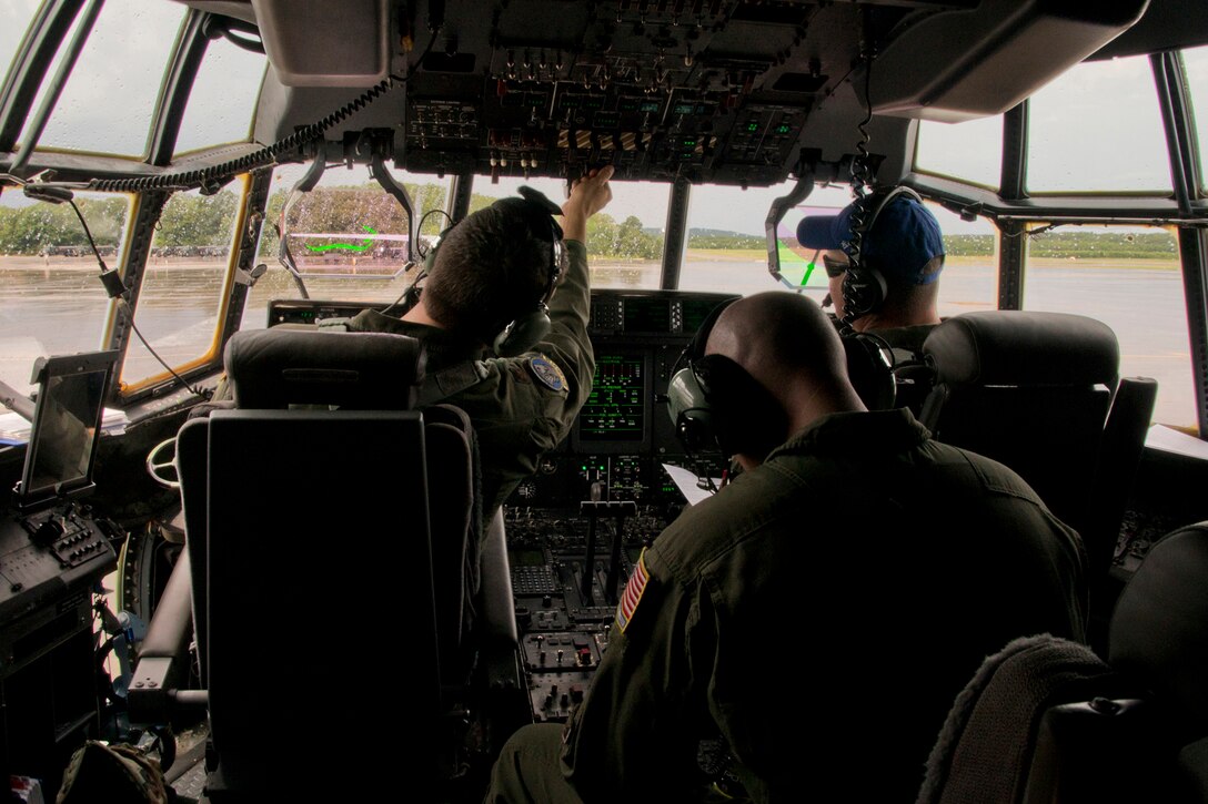 (From Left) U.S. Air Force Reserve Maj. Peter Hughes, pilot, Master Sgt. Michael Hopson, loadmaster, and Lt. Col. Chris Dickens, assistant operations officer, prepare a C-130J Super Hercules for takeoff June 15, 2017, at Little Rock Air Force Base, Ark. All three Airmen are assigned to the 327th Airlift Squadron, 913th Airlift Group, and were part of the Group’s first 3-ship mission manned entirely by Reserve Airmen. (U.S. Air Force photo by Master Sgt. Jeff Walston/Released)