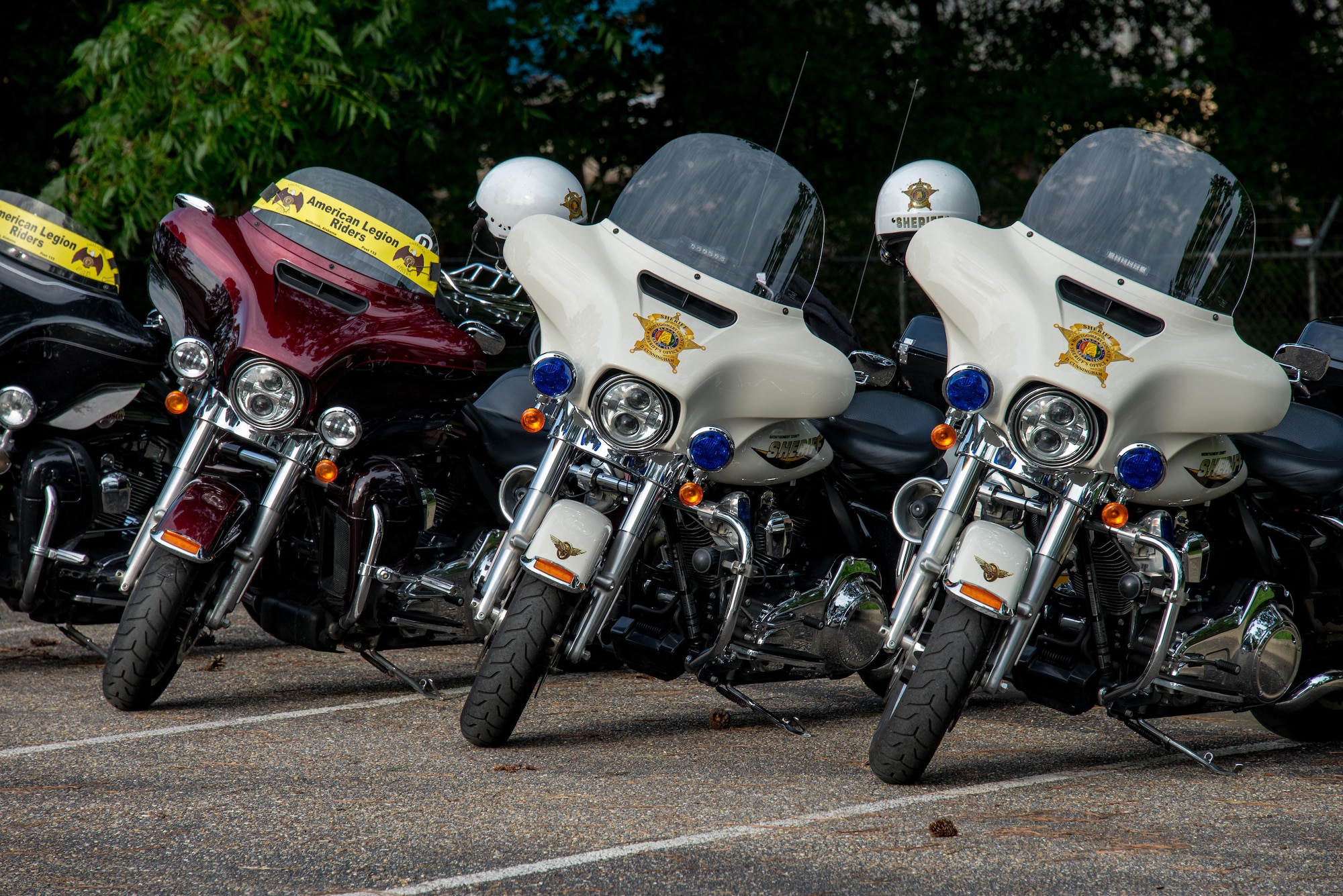 Montgomery County Sherriff Department cruisers and American Legion motorcycles line a parking lot on Maxwell Air Force Base, Ala., during Motorcycle Safety Day, June 27, 2017. Motorcycle Safety Day was held to have multiple cycle riders from throughout base come together and focus on how to become a safer and better rider. (US Air Force photo/Melanie Rodgers Cox/Released)