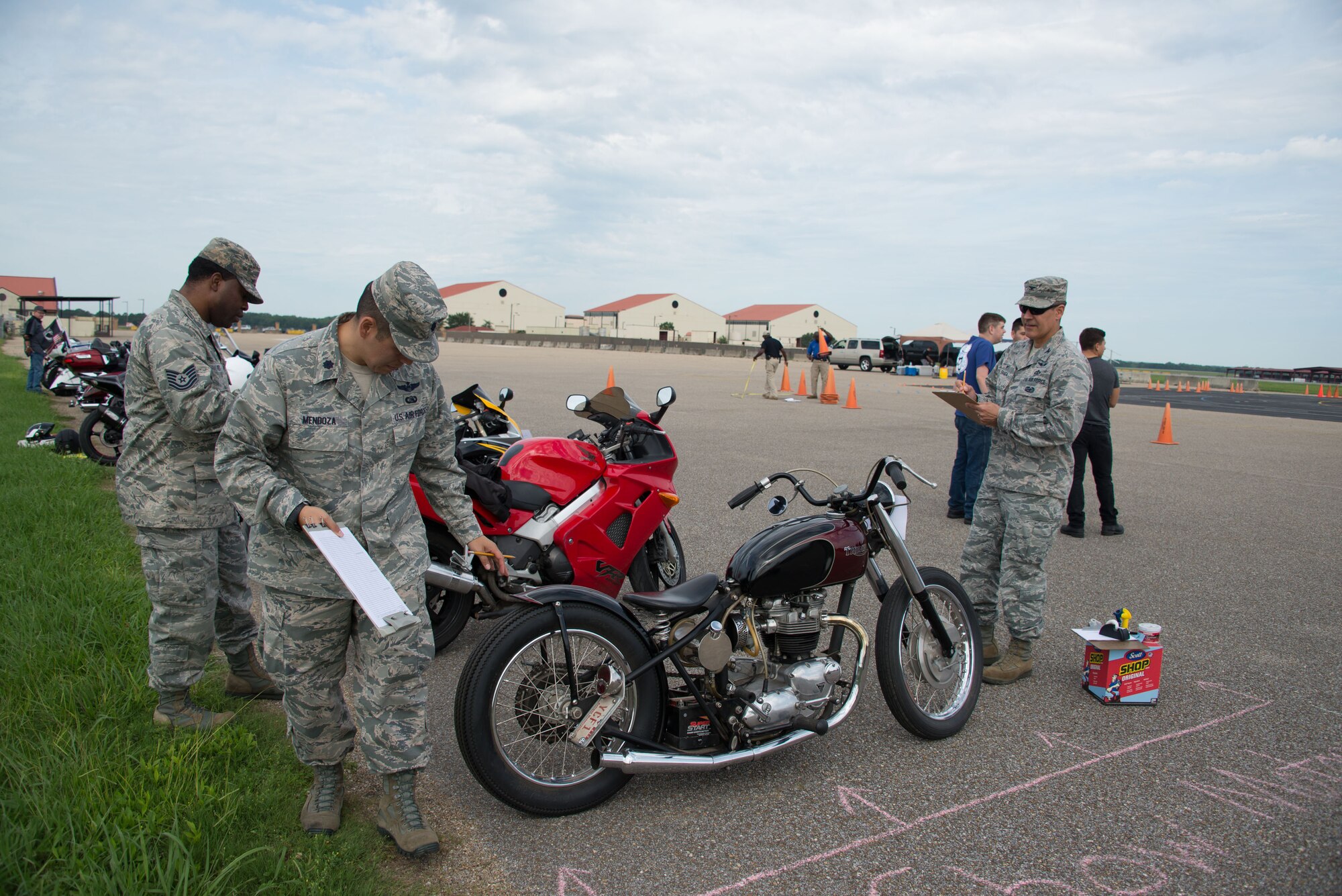 Col. Eric Shafa, 42nd Air Base Wing commander, and Lt. Col. Daniel Mendoza, 42nd ABW chief of safety, judge motorcycles during Motorcycle Safety Day, on Maxwell Air Force Base, Ala., June 27, 2017. The motorcycle show was one of four categories motorcyclists could enter during the safety day. (US Air Force photo/Trey Ward/Released)