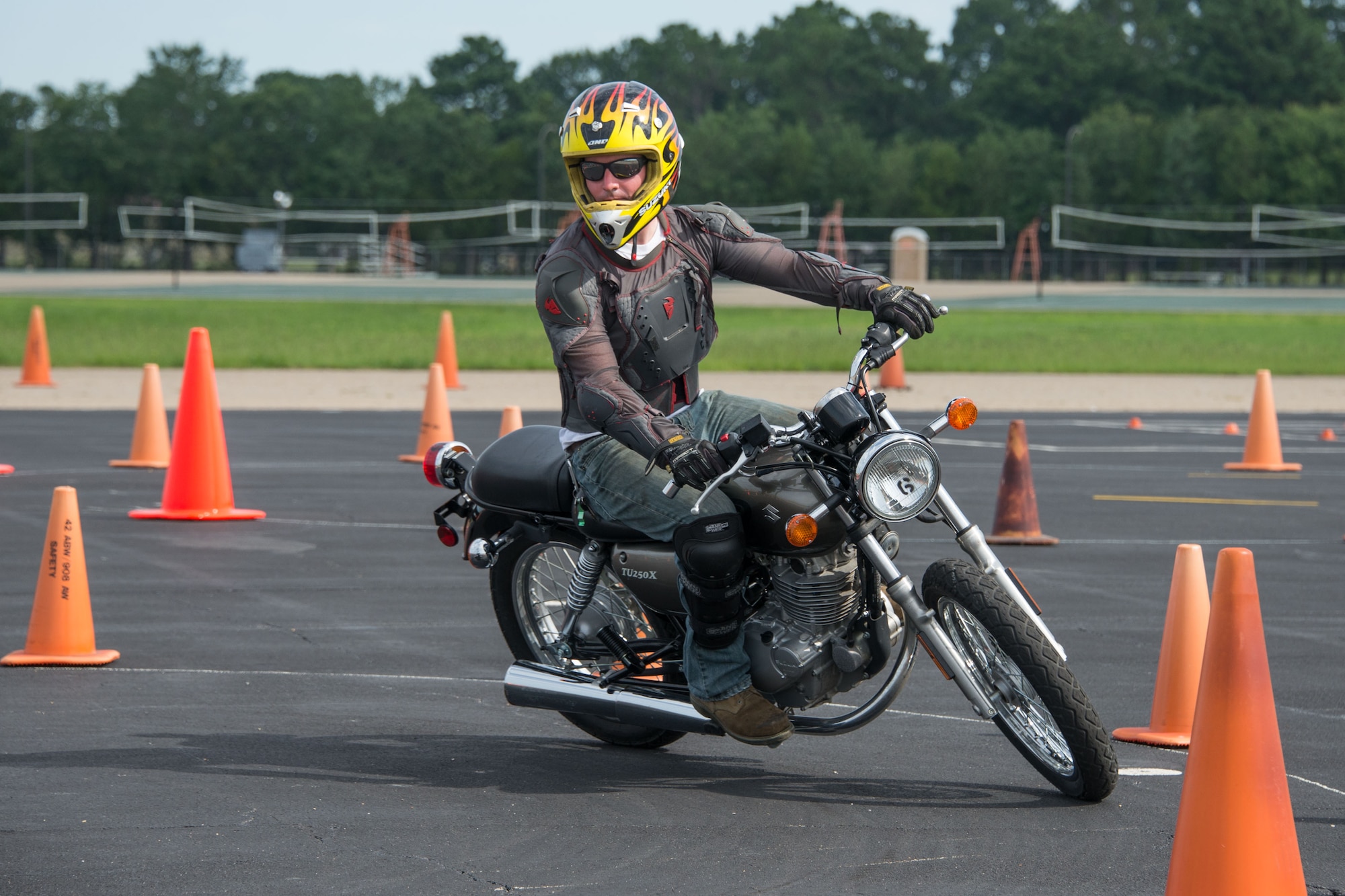 Staff Sgt. Jody Perkins, Air Force Life Cycle Management Center, rounds a turn during a timed motorcycle course, during the Motorcycle Safety Day, June 27, 2017. The timed course was one of four courses motorcyclists could participate in during the safety day. (US Air Force photo/Trey Ward/Released)