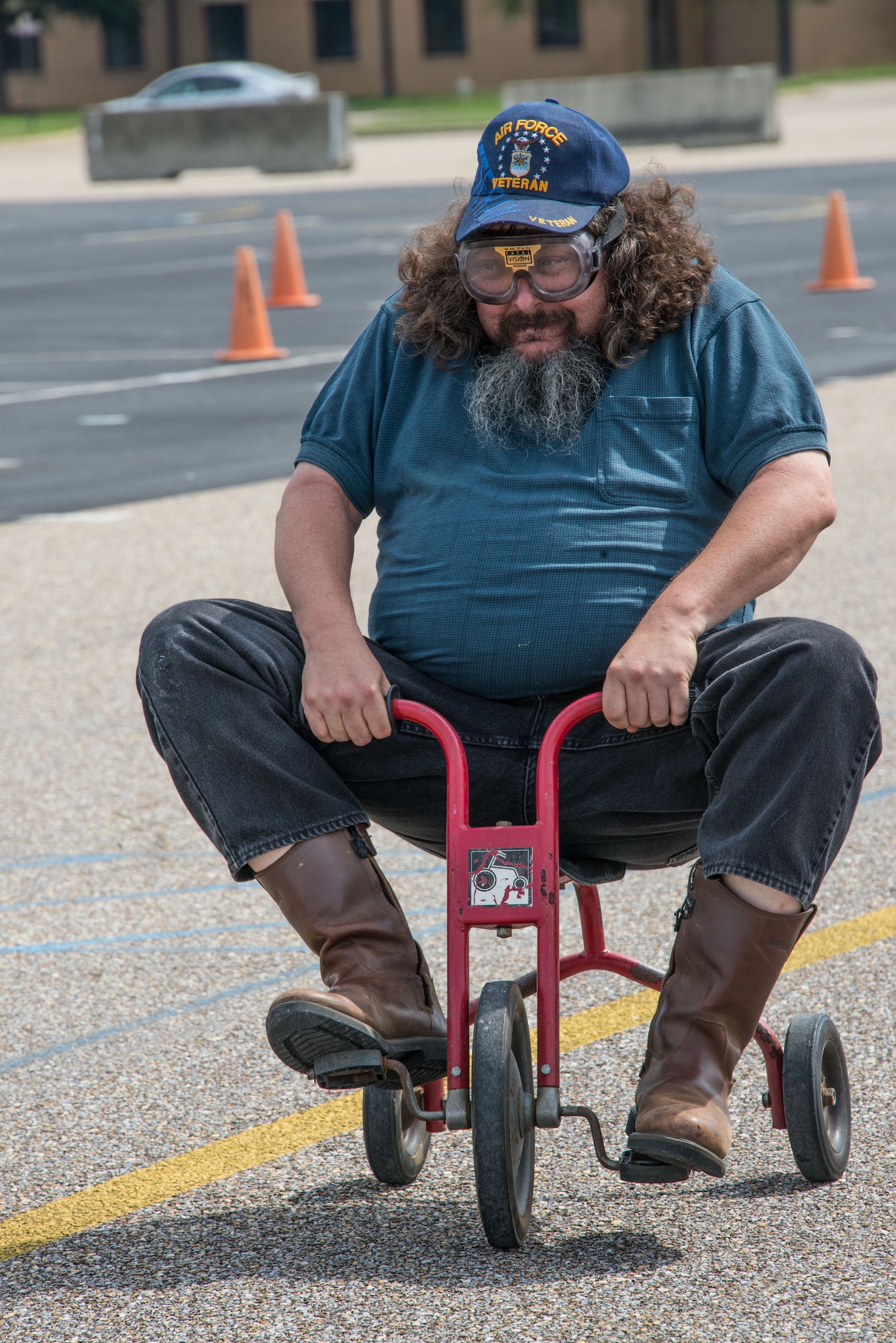 Jim Garner, Lemay Center, rides a tricycle during Motorcycle Safety Day on Maxwell Air Force Base, Ala., June 27, 2017. This event during safety day simulated a drunk driver. (US Air Force photo/Trey Ward/Released)