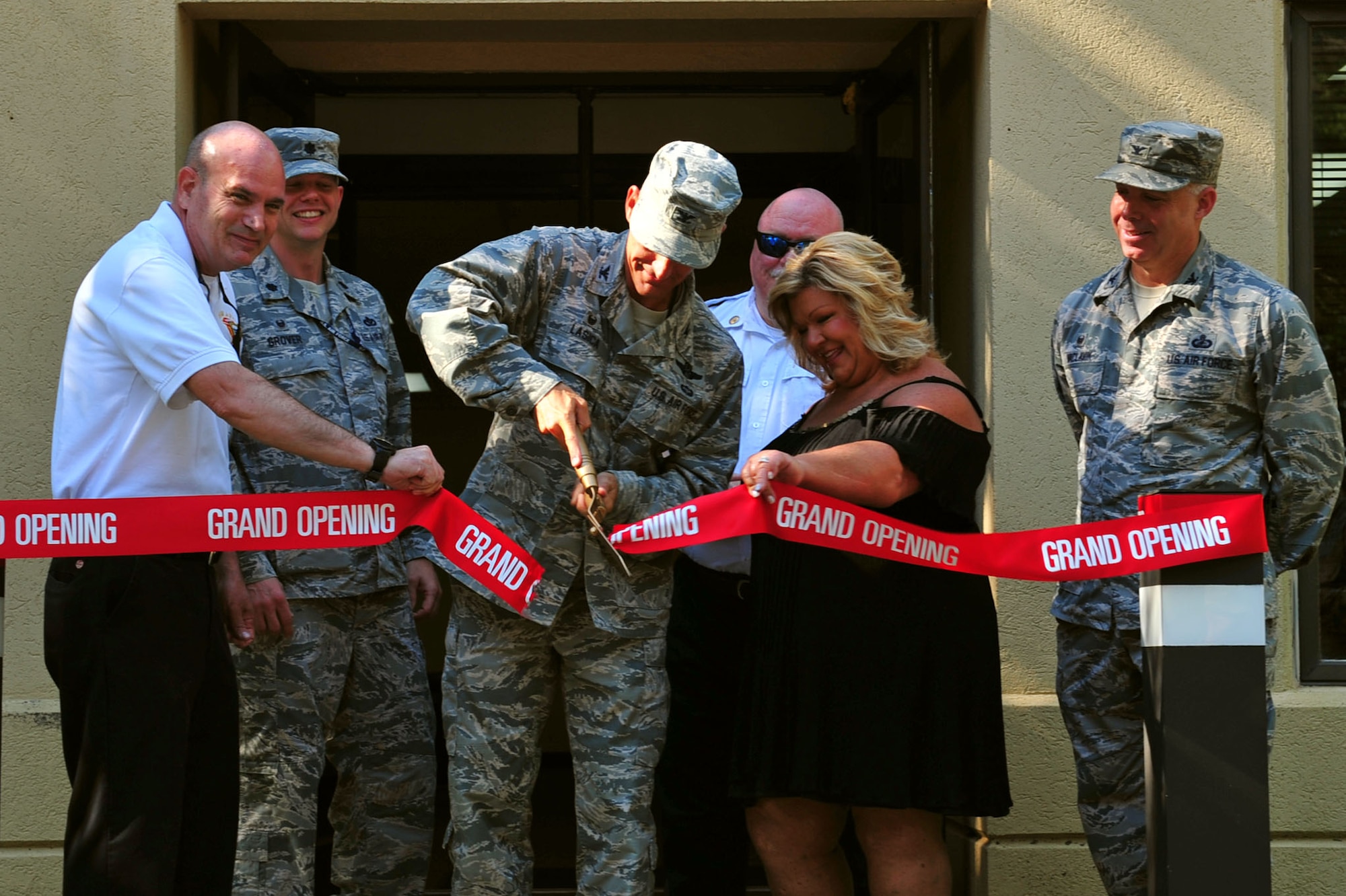 U.S. Air Force Col. Daniel Lasica, 20th Fighter Wing commander cuts a ribbon during the opening ceremony of a new 20th Civil Engineer Squadron fire station at Shaw Air Force Base, S.C., June 29, 2017. Construction for the station, which was built to accommodate up to five Airmen and one fire truck, began in January 2017. (U.S. Air Force photo by Airman 1st Class Kathryn R.C. Reaves)