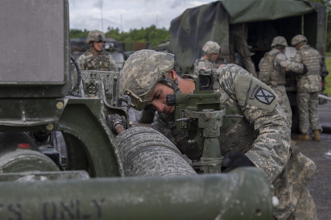 Army Spc. Bradford Dupras prepares an M119A3 105 mm howitzer before participating in a live-fire exercise at Fort Drum, N.Y., June 20, 2017. Dupras is assigned to the Massachusetts Army National Guard’s Charlie Battery, 1st Battalion, 101st Field Artillery Regiment, 86th Infantry Brigade Combat Team (Mountain). Army National Guard photo by Spc. Avery Cunningham