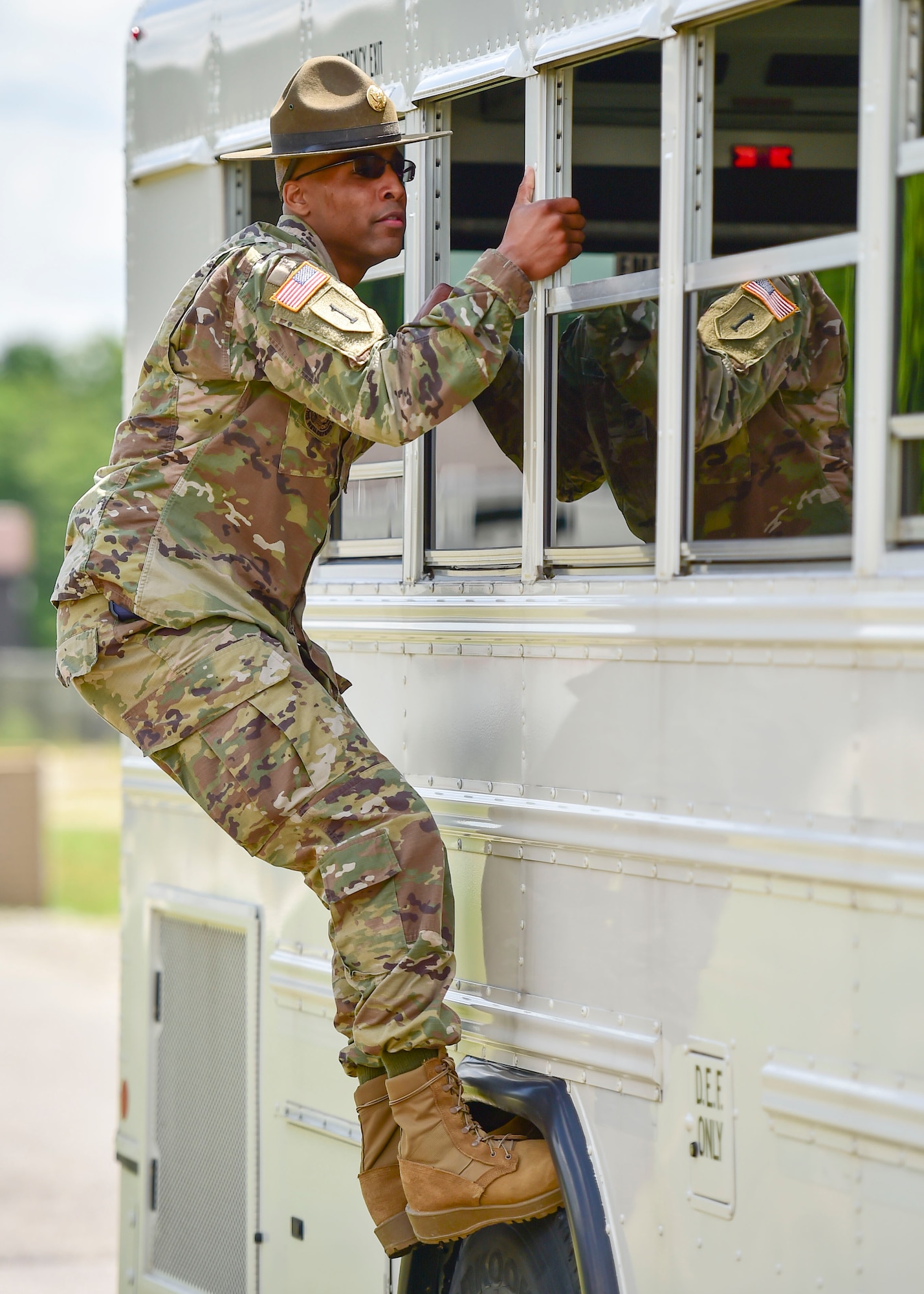 U.S. Army Staff Sgt. Brandon Curry, a drill sergeant with the 1st Bn., 390th Inf. Reg., tells Junior Reserve Officer Training Corps (JROTC) cadets to get off his bus during an encampment here, June 21, 2017. The encampment, facilitated by 910th Airlift Wing Airmen and Curry, provided a five-day experience teaching military skills and replicating aspects of Basic Military Training. JROTC is a program sponsored by the Armed Forces for high school students across the country. (U.S. Air Force photo/Eric White)