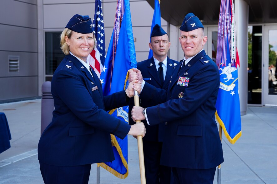 Col. DeAnna Burt, 50th Space Wing commander, passes the 50th Mission Support Group guidon to Col. Brian Kehl during the group’s change of command ceremony at Schriever Air Force Base, Colorado, Tuesday, June 27, 2017. Kehl assumed command of the group from Col. Jason Janaros. (U.S. Air Force photo/Christopher DeWitt)
