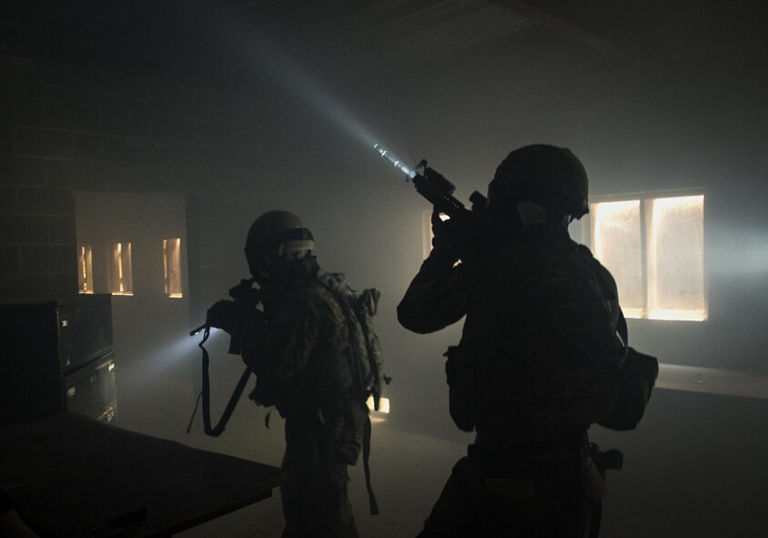 Airmen from the 822d Base Defense Squadron storm a building to rescue a simulated hostage rescue during the Scorpion Fire Team Challenge, June 28, 2017, at Moody Air Force Base, Ga. The challenge was designed to push the Airmen to their physical and mental limits, by incorporating written tests, hostage rescues, blindfolded weapons assembly and physical exertion sessions among 14 other challenges. Eighteen four-person teams competed during the two-day event for various prizes and bragging rights. (U.S. Air Force photo by Senior Airman Janiqua P. Robinson)