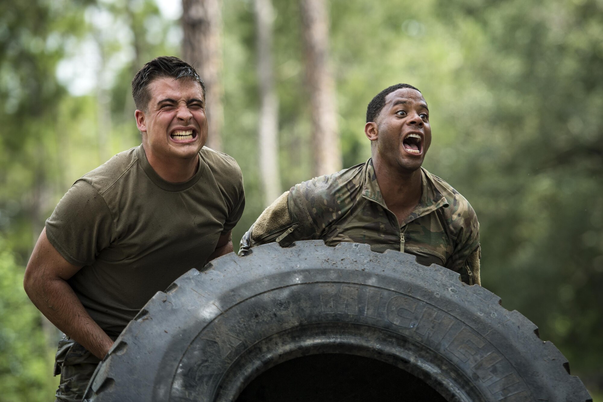 Airmen from the 822d Base Defense Squadron flip a tire during the Scorpion Fire Team Challenge, June 29, 2017, at Moody Air Force Base, Ga. The challenge was designed to push the Airmen to their physical and mental limits, by incorporating written tests, hostage rescues, blindfolded weapons assembly and physical exertion sessions among 14 other challenges. Eighteen four-person teams competed during the two-day event for various prizes and bragging rights. (U.S. Air Force photo by Senior Airman Janiqua P. Robinson)