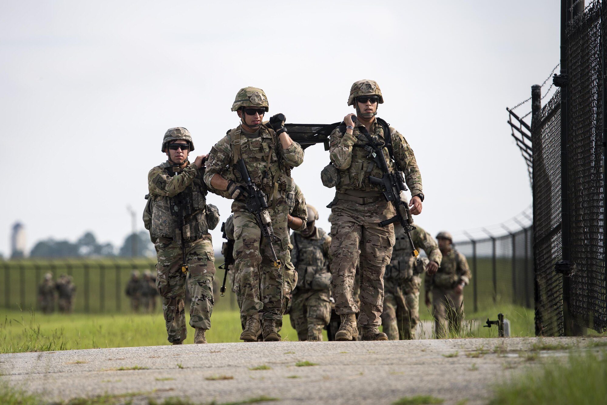 Airmen from the 822d Base Defense Squadron carry a litter during the Scorpion Fire Team Challenge, June 28, 2017, at Moody Air Force Base, Ga. The challenge was designed to push the Airmen to their physical and mental limits by incorporating written tests, hostage rescues, blindfolded weapons assembly and physical exertion sessions, among 14 other challenges. Eighteen four-person teams competed during the two-day event for various prizes and bragging rights. (U.S. Air Force photo by Senior Airman Janiqua P. Robinson) 