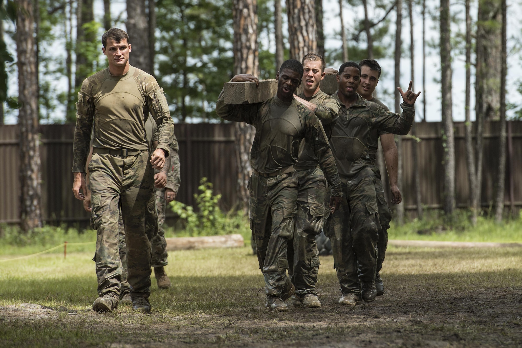 Airmen from the 822d Base Defense Squadron carry a wooden block during the Scorpion Fire Team Challenge, June 29, 2017, at Moody Air Force Base, Ga. The challenge was designed to push the Airmen to their physical and mental limits, by incorporating written tests, hostage rescues, blindfolded weapons assembly and physical exertion sessions among 14 other challenges. Eighteen four-person teams competed during the two-day event for various prizes and bragging rights. (U.S. Air Force photo by Senior Airman Janiqua P. Robinson)