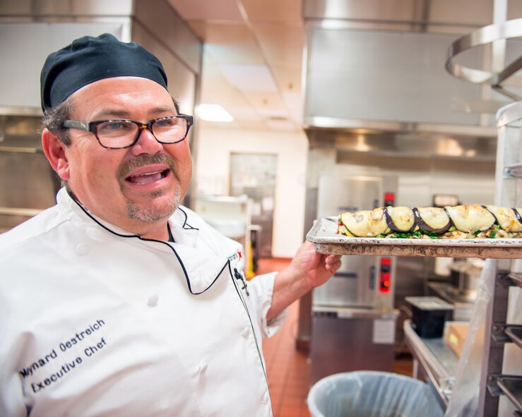 Maynard Oestreich, executive chef for Aramark prepares meals prior to the Airmen Leadership School graduation at Travis Air Force Base, Calif., June 28, 2017. Oestreich a former U.S. Navy veteran and an award-winning chef from Napa Valley, Calif., took the head chef position so he could mentor young Airmen. (U.S. Air Force photo by Louis Briscese)