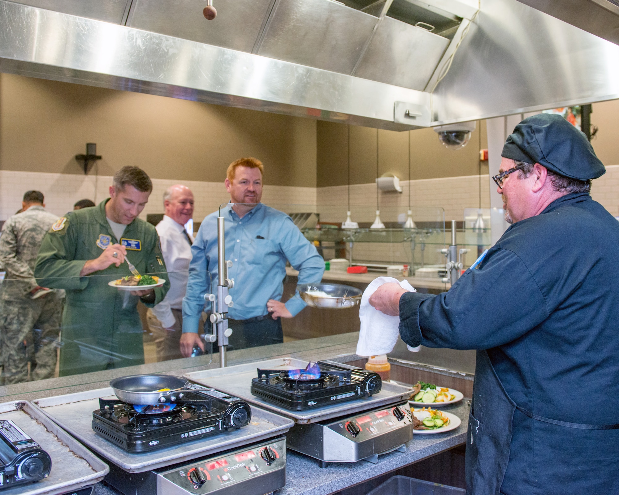 Maynard Oestreich, executive chef for Aramark prepares meals during the BIBIM Box tasting featuring Korean food at Sierra Inn Dining Facility, Travis Air Force Base, Calif., June 29, 2017. Oestreich a former U.S. Navy veteran and an award-winning chef from Napa Valley, Calif., took the head chef position so he could mentor young Airmen. (U.S. Air Force photo by Louis Briscese)