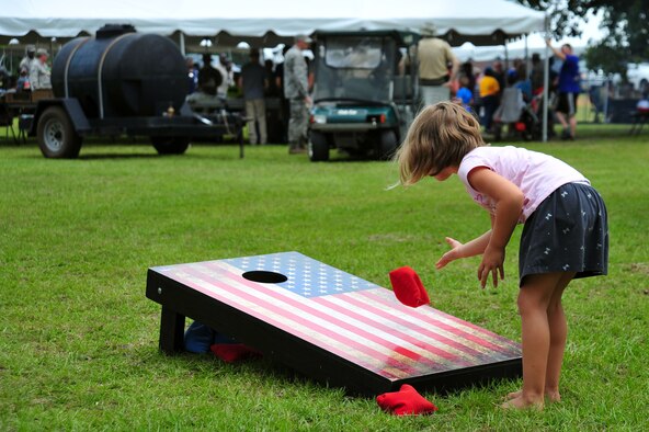 A Team Shaw child plays cornhole during the Freedom Bash at Shaw Air Force Base, S.C., June 30, 2017. The 20th Force Support Squadron hosted the annual event in celebration of Independence Day. (U.S. Air Force photo by Airman 1st Class Kathryn R.C. Reaves)