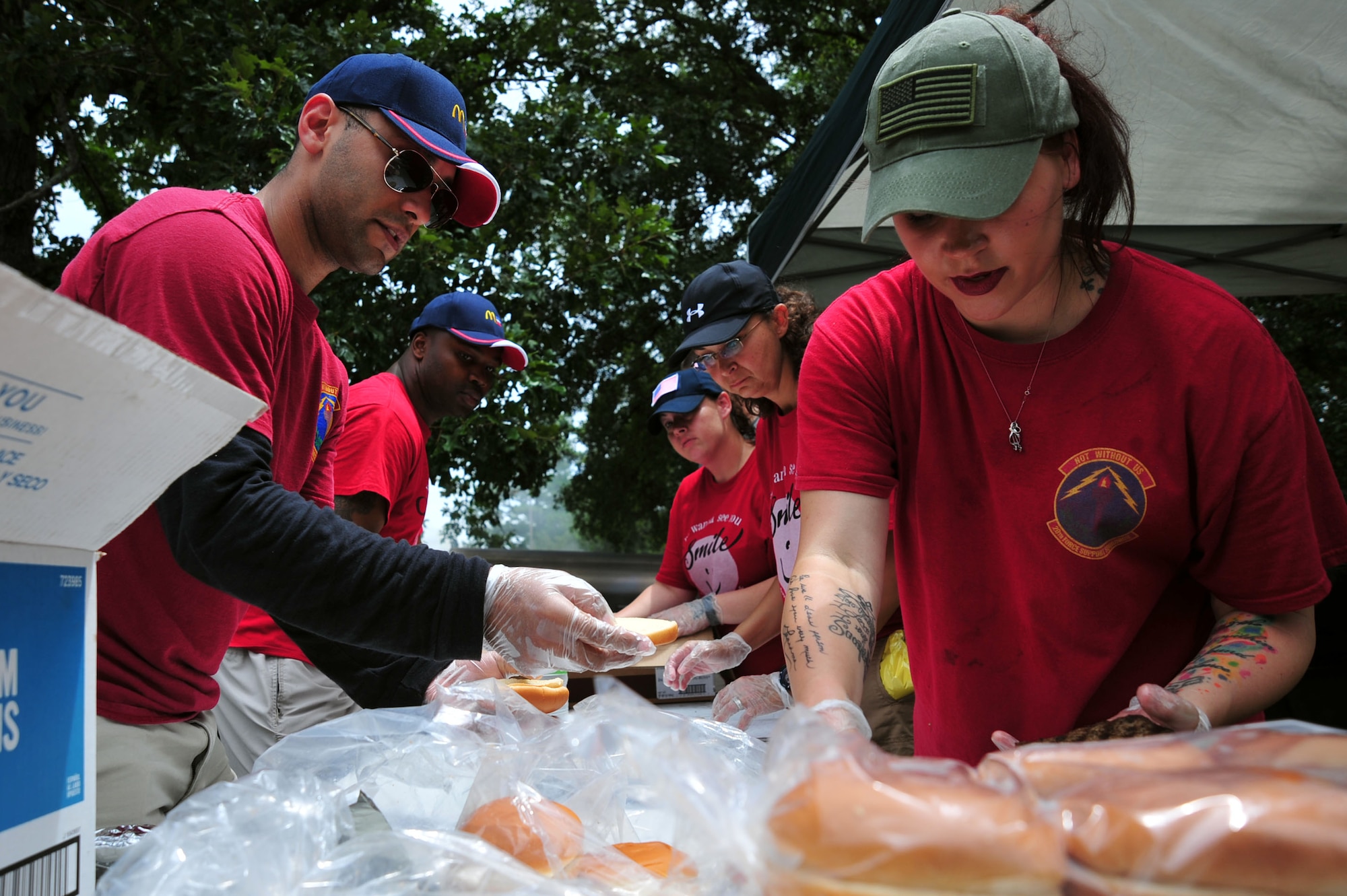 Airmen from the 20th Force Support Squadron (FSS) prepare food during the Freedom Bash at Shaw Air Force Base, S.C., June 30, 2017. The annual morale event hosted by the 20th FSS is intended to give Airmen and families quality time to come together. (U.S. Air Force photo by Airman 1st Class Kathryn R.C. Reaves)