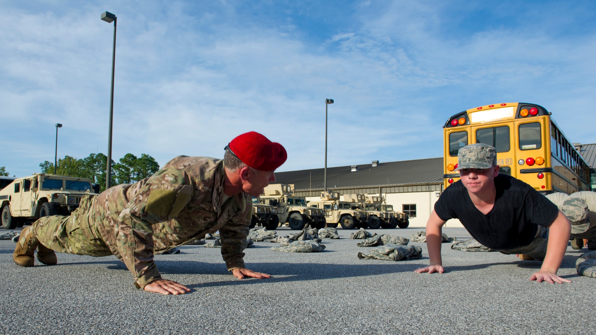 Retired Col. Kenneth Rodriguez, director of Junior ROTC Summer Leadership School, motivates a cadet while doing push-ups at Hurlburt Field, Fla., June 26, 2017. More than 60 JROTC cadets from five local high schools engaged in a variety of team-building and leadership skill-developing exercises during a Summer Leadership School trip to Hurlburt Field, June 26 – 30. (U.S. Air Force photo by Staff Sgt. Victor J. Caputo)