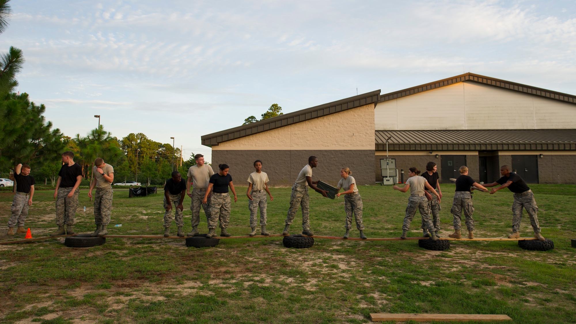 Junior ROTC cadets pass equipment across a makeshift bridge of tires and planks during a team-building exercise at Hurlburt Field, Fla., June 26, 2017. The JROTC Summer Leadership School program brought more than 50 cadets to Hurlburt Field to engage in a variety of team-building and leadership skill-developing exercises under the guidance of Air Commandos, June 26 – 30. (U.S. Air Force photo by Staff Sgt. Victor J. Caputo)