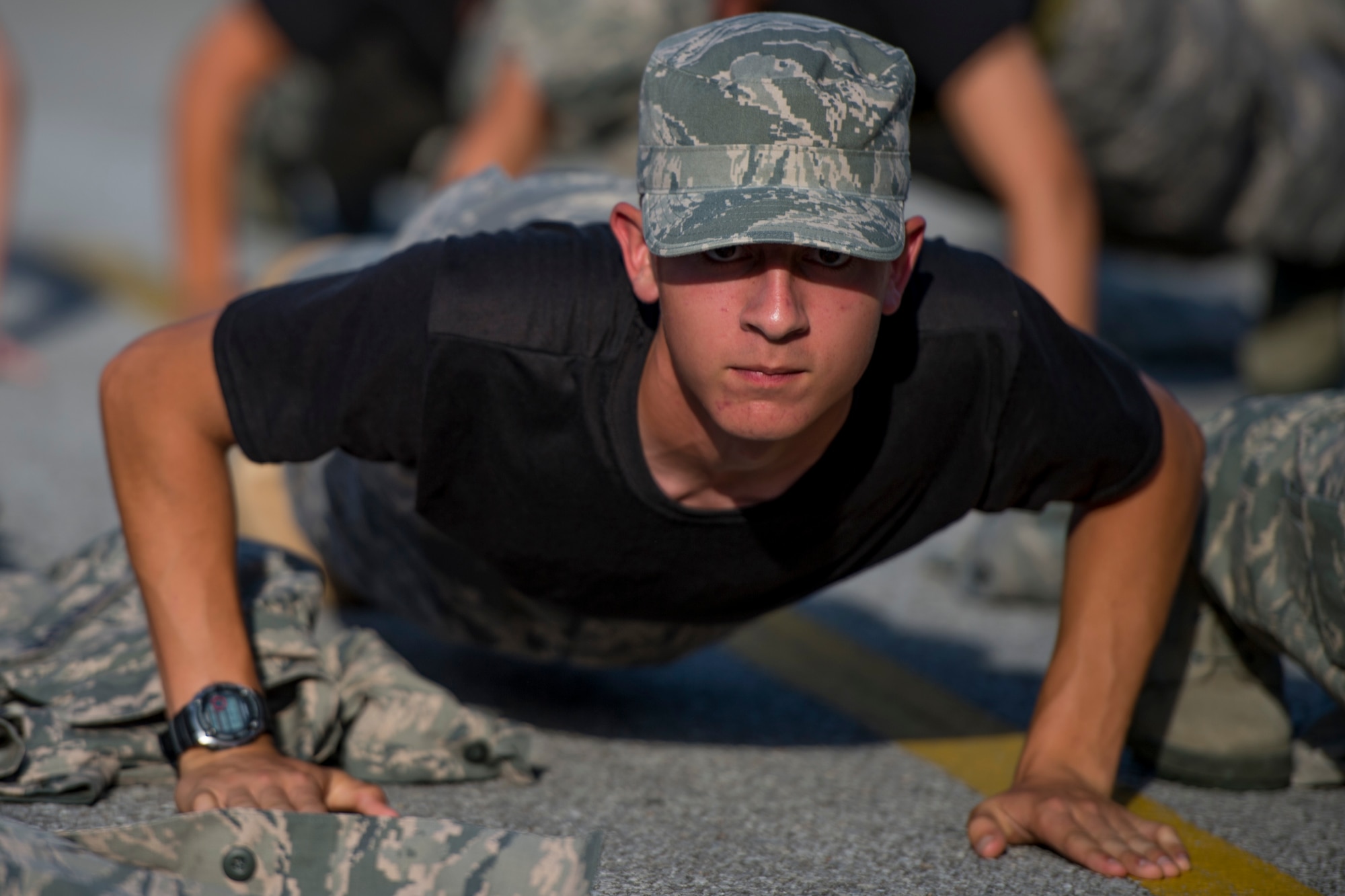 A Junior ROTC cadet performs push-ups with his wingmen during a JROTC Summer Leadership School trip to Hurlburt Field, Fla., June 26, 2017. More than 50 cadets visited the base to engage in a variety of team-building and leadership skill-developing exercises under the guidance of Air Commandos from across Hurlburt Field. (U.S. Air Force photo by Staff Sgt. Victor J. Caputo)