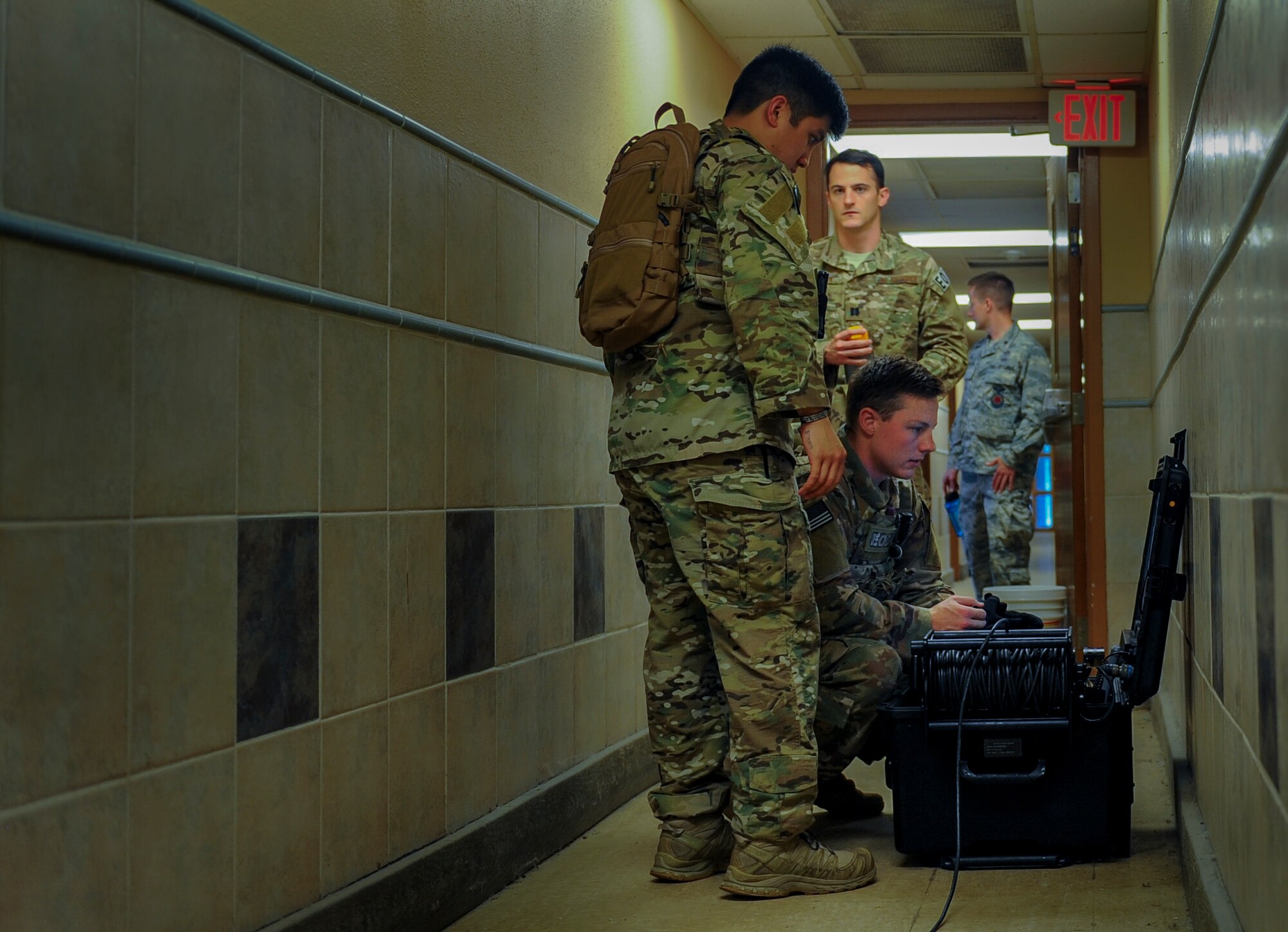 Explosive ordnance disposal technicians with the 1st Special Operations Civil Engineering Squadron operate an X-Ray machine during a hostage exercise at Hurlburt Field, Fla., June 21, 2017. This machine allows technicians to investigate explosives during bomb threat scenarios. The exercise placed EOD technicians through real-world situations, testing their abilities in disarming bombs and ensuring their readiness for global operations. (U.S. Air Force photo by Airman 1st Class Isaac O. Guest IV)