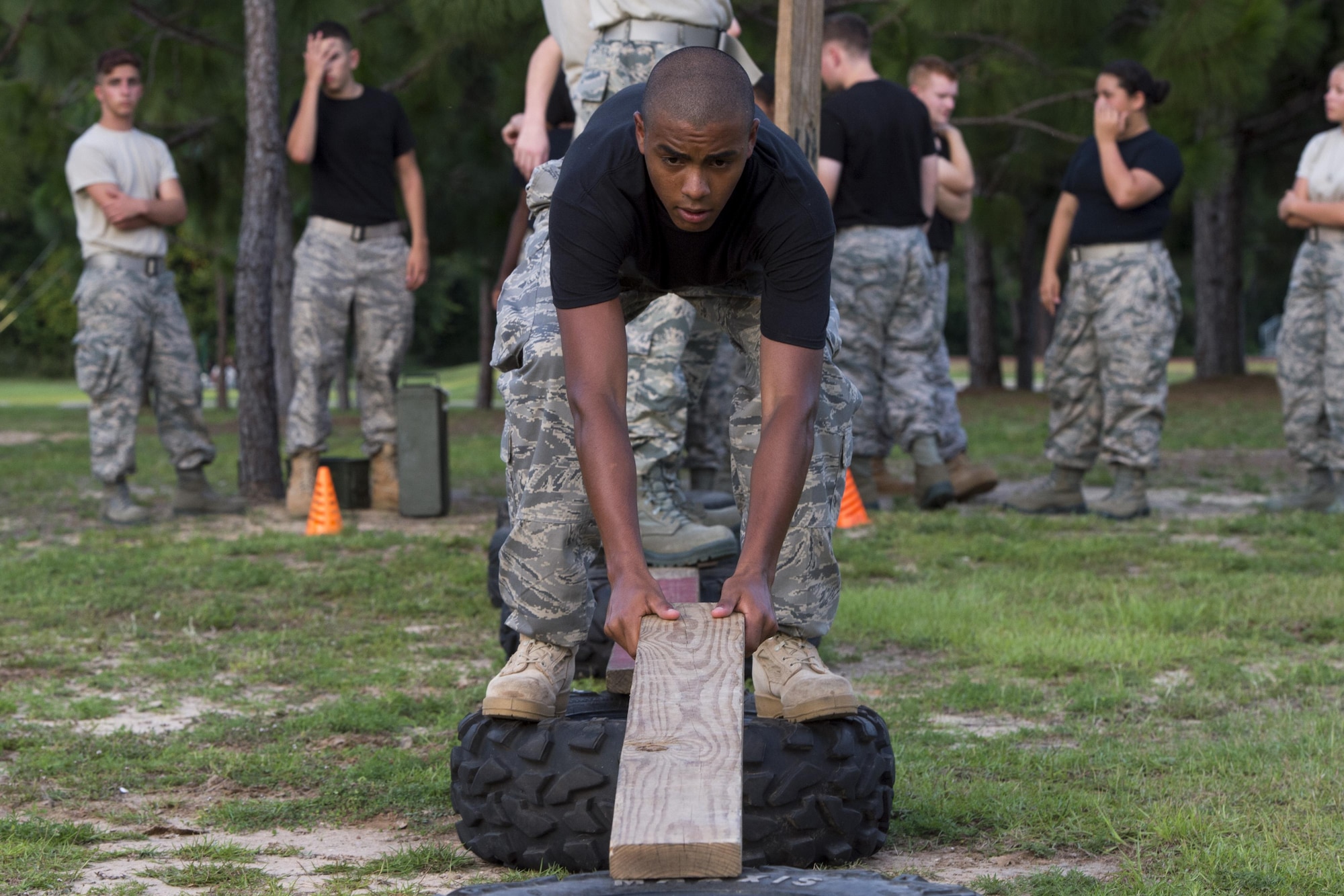 A Junior ROTC cadet lays a plank down to form a makeshift bridge between two tires during a team-building exercise at Hurlburt Field, Fla., June 26, 2017. More than 50 JROTC cadets from five local high schools engaged in a variety of team-building and leadership skill-developing exercises during a Summer Leadership School trip to Hurlburt Field, June 26 – 30. (U.S. Air Force photo by Staff Sgt. Victor J. Caputo)