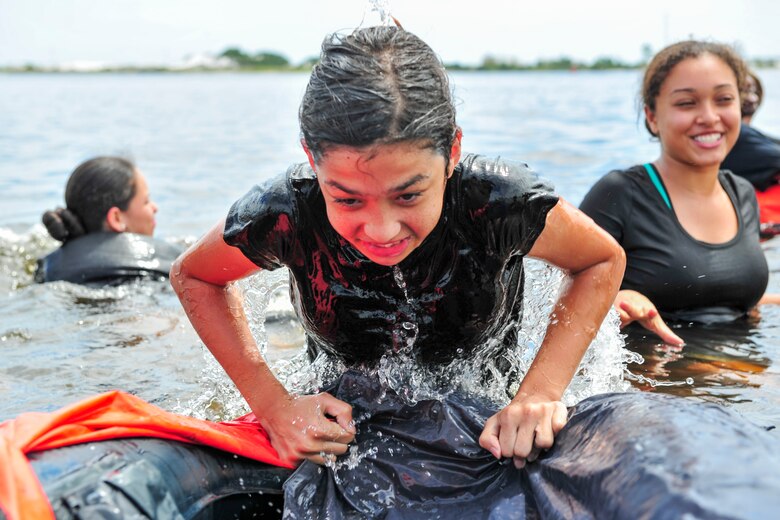 A Junior ROTC cadet pulls herself into a life raft during survival, evasion, resistance and escape training at Hurlburt Field, Fla., June 29, 2017. More than 50 cadets from five local high schools attended the week-long Summer Leadership School course at Hurlburt Field, where they learned about teamwork, leadership and life in the military. (U.S. Air Force photo by Staff Sgt. Victor J. Caputo)