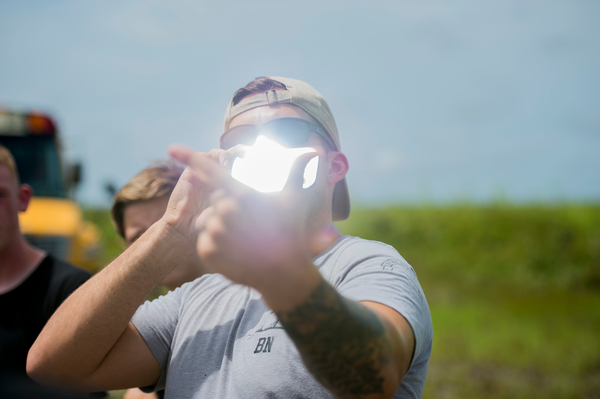 Senior Airman Heath Jolley, a survival, evasion, resistance and escape specialist with the 1st Special Operations Support Squadron, demonstrates how to signal with a mirror during SERE water survival training at Hurlburt Field, Fla., June 29, 2017. More than 50 cadets from five local high schools attended the Summer Leadership School at Hurlburt Field, where they learned about leadership, teamwork and life in the military. (U.S. Air Force photo by Staff Sgt. Victor J. Caputo)