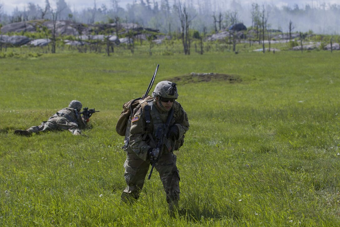 A Vermont Army National Guard member rushes to deliver a message to his comrades during a live-fire exercise at Fort Drum, N.Y., June 21, 2017. Army National Guard photo by Spc. Avery Cunningham