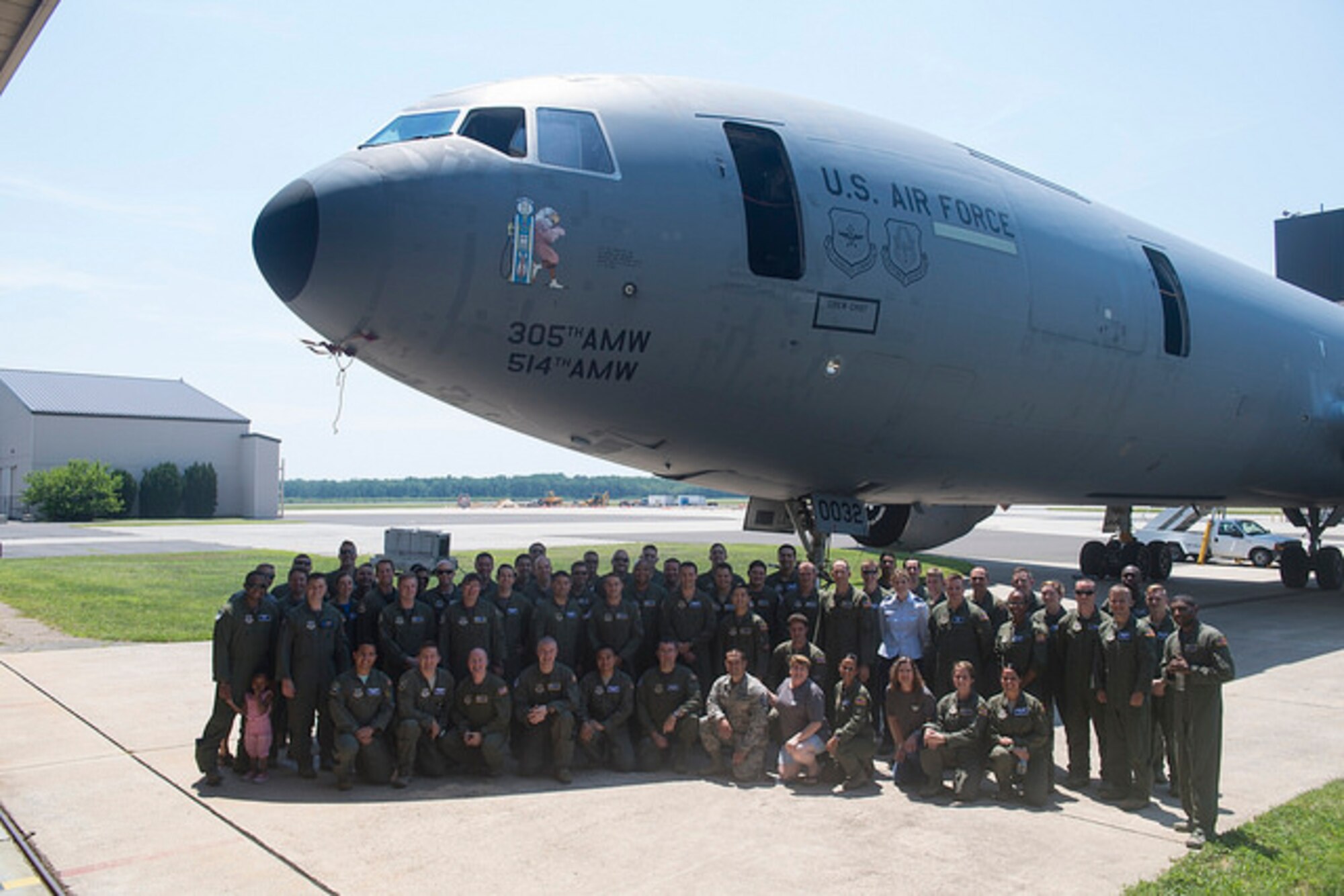 Current members of the 32d Air Refueling Squadron pose in front of a KC-10 Extender at Joint Base McGuire-Dix-Lakehurst, N.J. June 30. The 32d celebrated their 100 year anniversary and revealed their commemorative nose art