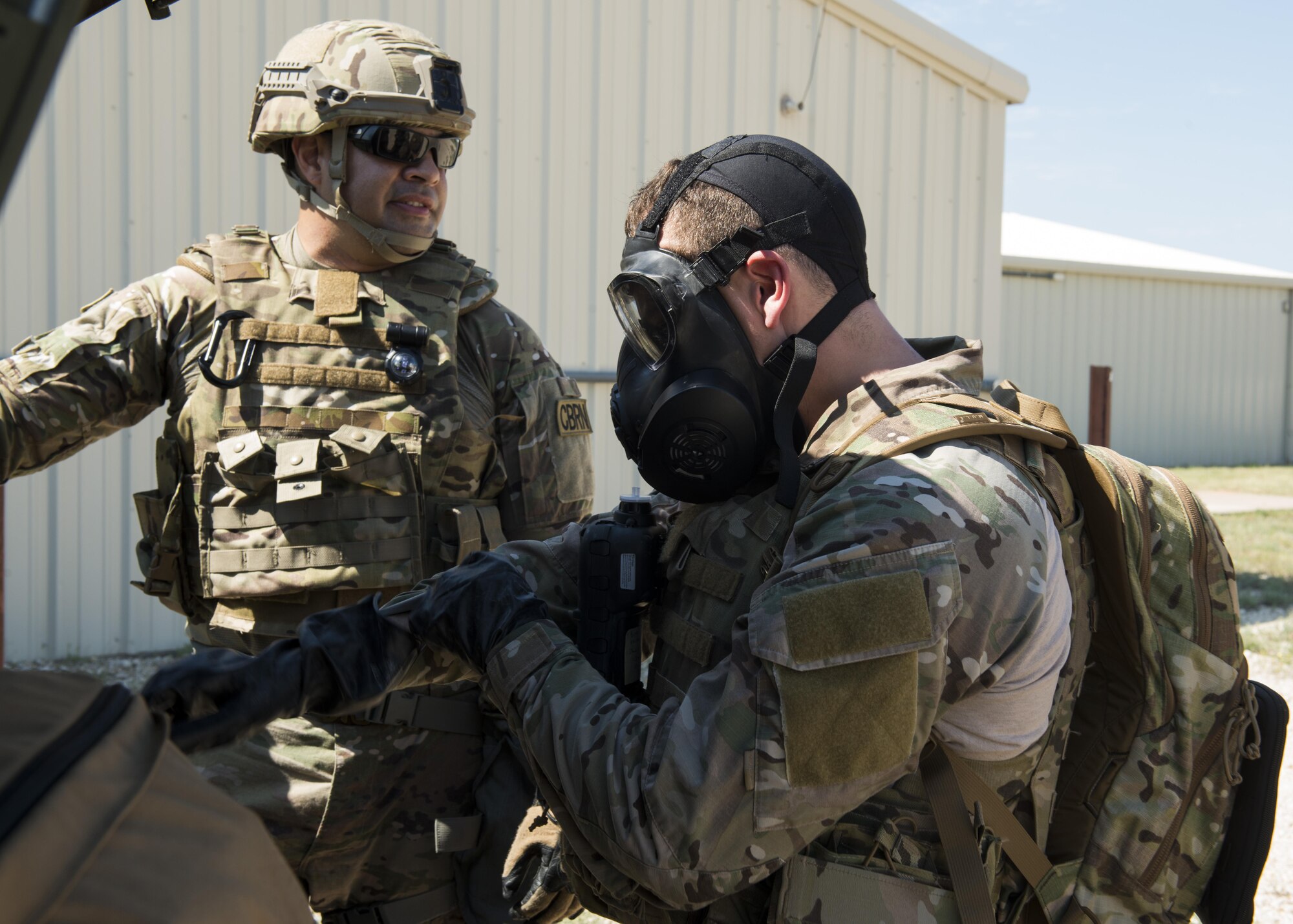 U.S. Air Force Staff Sgts. Dominic Garcia (left), 7th Civil Engineer Squadron emergency management journeyman and Joshua Oliver, 7th Civil Engineer Squadron explosive ordnance disposal journeyman (right), prepare for a training exercise at Dyess Air Force Base, Texas, June 29, 2017. Emergency management personnel often participate in exercises with EOD to show them first-hand what they can expect when in a deployed environment. (U.S. Air Force photo by Senior Airman Katherine Miller)