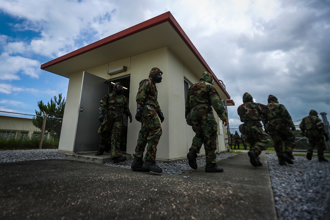 U.S. Marines with 1st Battalion, 3rd Marine Regiment, exit the gas chamber during annual gas chamber qualification aboard Camp Hansen, Okinawa, Japan, June 26, 2017. The annual training familiarizes Marines with the use of their gas mask to prepare them for a biological or chemical attack. The Hawaii-based battalion is forward deployed to Okinawa, Japan as part of the Unit Deployment Program. (U.S. Marine Corps photo by Cpl. Aaron S. Patterson/Released)