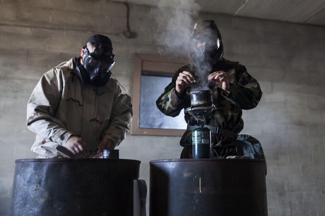 Cpl. Devin Nipppagan and Pfc. Tyler Peterson, chemical, biological, radiological and nuclear defense specialists with Combat Logistics Battalion 3, activates an o-chloronitrobenzene malononitrile capsule aboard Marine Corps Base Hawaii on June 28, 2017. The gas chamber is a biennial training event that prepares Marines for when they’re exposed to chemical, biological, radiological or nuclear hazards. (U.S. Marine Corps photo by Lance Cpl. Matthew Kirk)