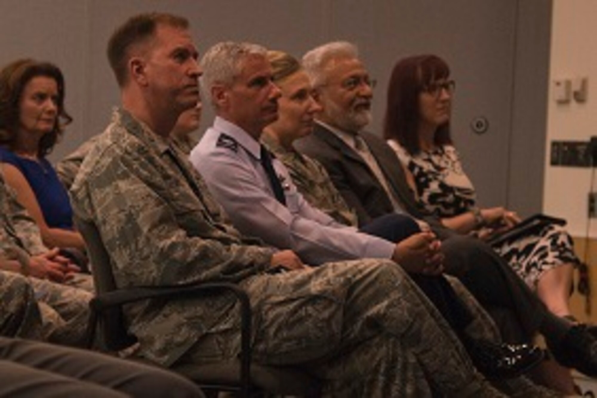 Audience members watch a video about Capt. David Schonberg, 113th Wing personnel officer, during a Lesbian, Gay, Bisexual and Transgender Pride Month special observance titled ‘LGBT: I am an American Airman’ at Joint Base Andrews, Md., June 29, 2017. The video highlighted Schonberg’s life, experience and extraordinary contributions as an openly gay military member. (U.S. Air Force photo by Airman 1st Class Valentina Lopez)