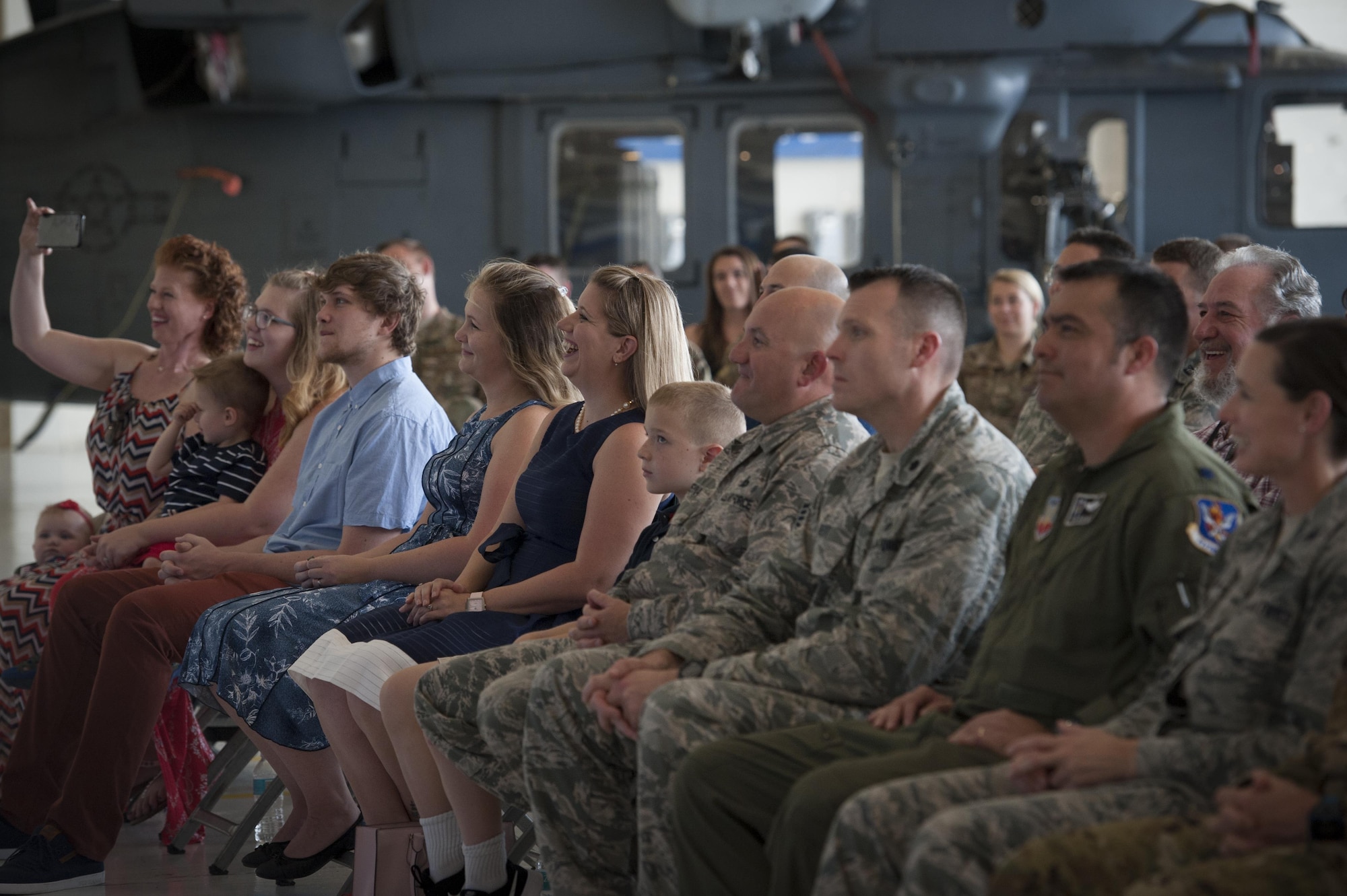 Family and friends watch and laugh during a promotion ceremony, June 28, 2017, at Moody Air Force Base, Ga. During the ceremony, then Maj. Christopher Dunston, 723d Aircraft Maintenance Squadron commander, promoted to lieutenant colonel and his younger cousin, then Senior Master Sgt. Brandon Dunston, 74th Aircraft Maintenance Unit superintendent, promoted to chief master sergeant. (U.S. Air Force photo by Airman 1st Class Lauren M. Sprunk)