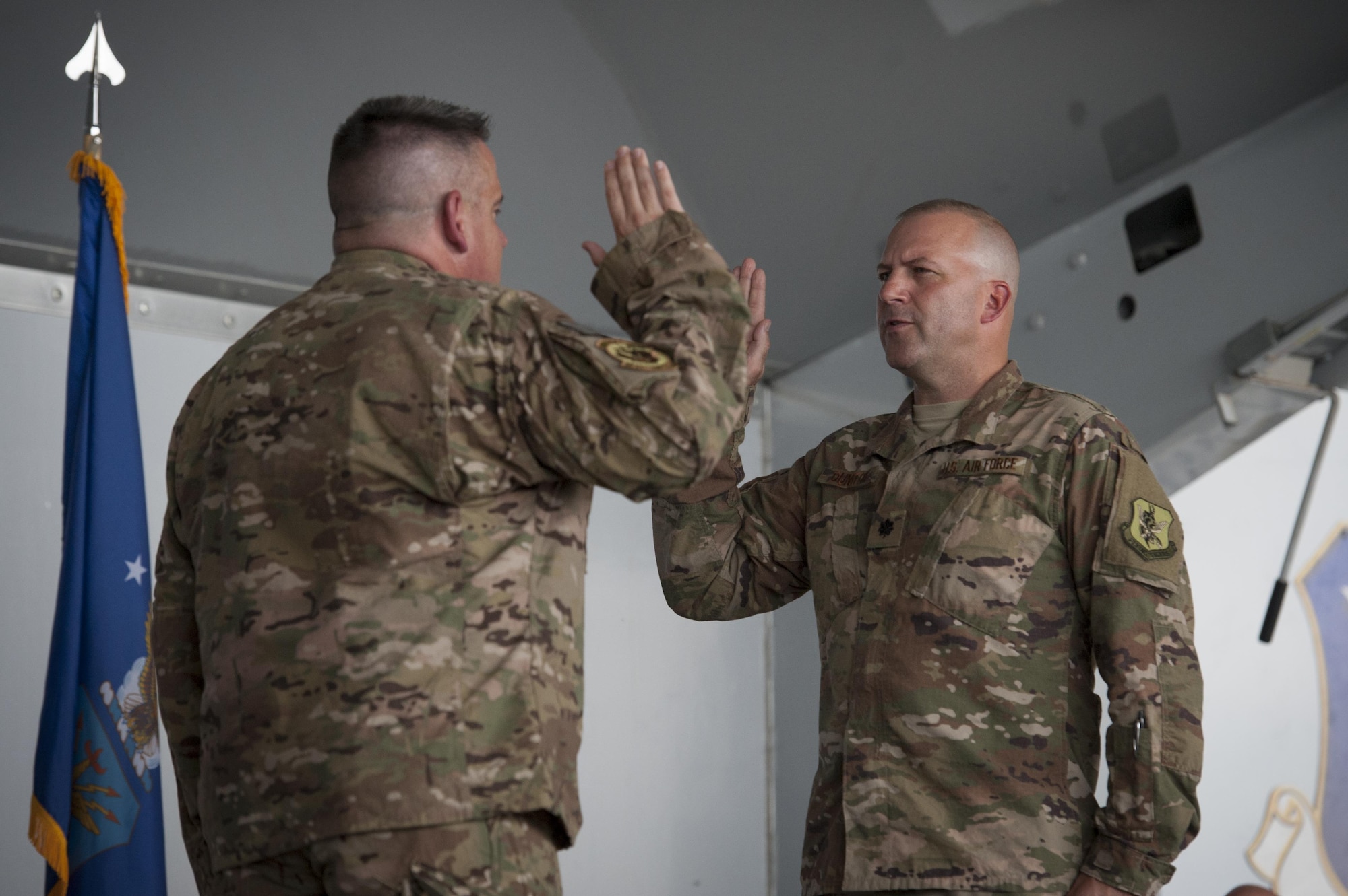 Col. Stephen Scherzer, 52d Maintenance Group commander, Spangdalhlem Air Base, Germany, administers the oath of office to Lt. Col. Christopher Dunston, 723d Aircraft Maintenance Squadron commander, during a promotion ceremony, June 28, 2017, at Moody Air Force Base, Ga. Scherzer traveled overseas to officiate the ceremony in which Chris promoted to lieutenant colonel and his younger cousin, then Senior Master Sgt. Brandon Dunston, 74th Aircraft Maintenance Unit superintendent, promoted to chief master sergeant. (U.S. Air Force photo by Airman 1st Class Lauren M. Sprunk)