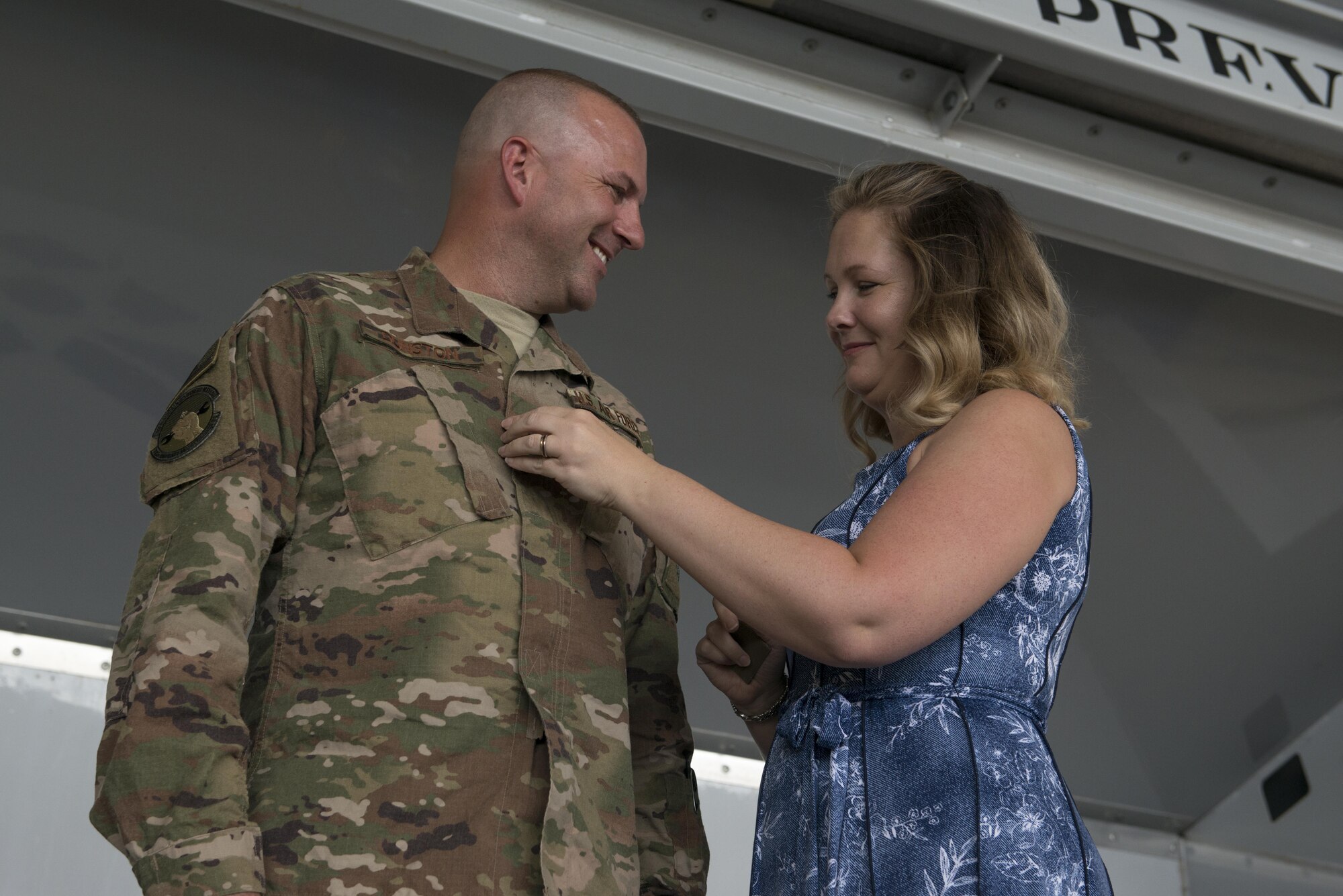 Lt. Col. Christopher Dunston, 723d Aircraft Maintenance Squadron commander, is tacked on by his wife during a promotion ceremony June 28, 2017, at Moody Air Force Base, Ga. During the ceremony, Chris promoted to lieutenant colonel and his younger cousin, then Senior Master Sgt. Brandon Dunston, 74th Aircraft Maintenance Unit superintendent, promoted to chief master sergeant. (U.S. Air Force photo by Airman 1st Class Lauren M. Sprunk)