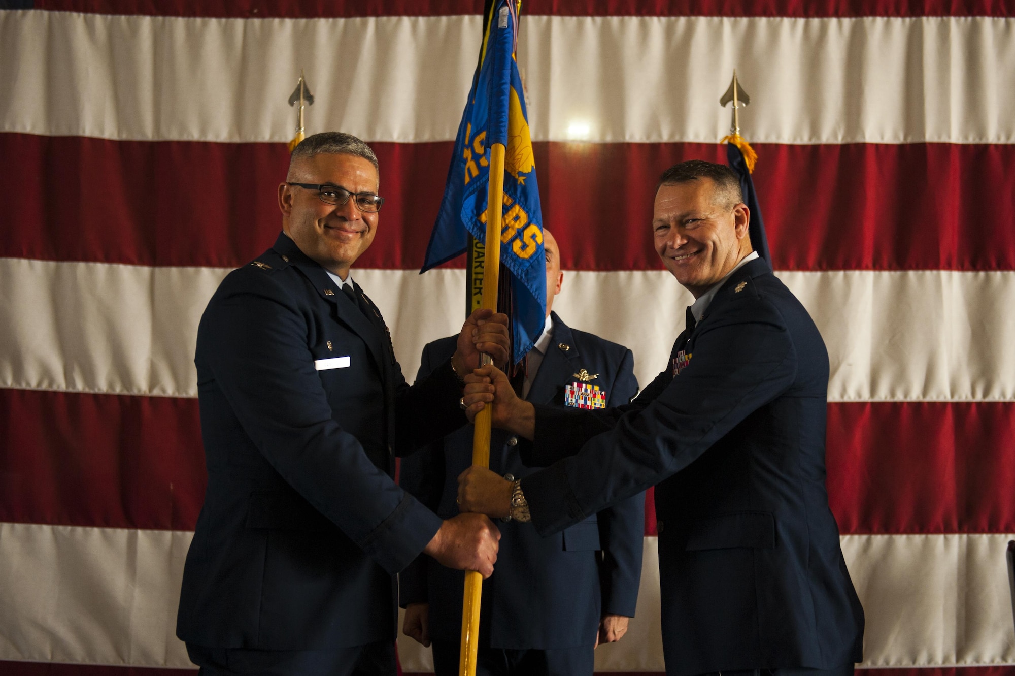 U.S. Air Force Lt. Col. Robert Kammerer, 316th Training Squadron Commander, receives the unit guideon from Col. Alejandro Ganster, 17th Training Group Commander, during the 316th TRS Change of Command at the Fire Academy high bay on Goodfellow Air Force Base, Texas, June 30, 2017. The change of command ceremony is a time honored military tradition that signifies the orderly exchange of authority.  (U.S. Air Force photo by Senior Airman Scott Jackson/Released)