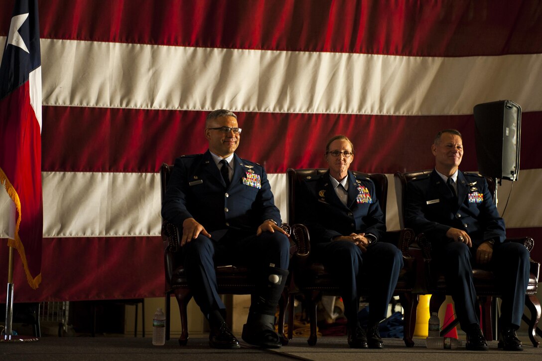 U.S. Air Force Col. Alejandro Ganster, 17th Training Group Commander, Lt. Col. Wendie Mount and Lt. Col. Robert Kammerer, 316th Training Squadron Commander, sit together during the 316th TRS Change of Command ceremony at the Fire Academy high bay on Goodfellow Air Force Base, Texas, June 30, 2017. Kammerer is the new 316th TRS commander. (U.S. Air Force photo by Senior Airman Scott Jackson/Released)