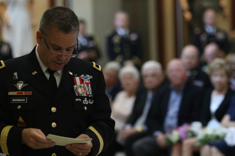Brig. Gen. Michael Warmack, Chief of Army Reserve Command Operations, Plans and Training, checks his notes during his retirement ceremony at Fort Bragg, N.C., June 29, 2017. Warmack honored  his wife and parents during the ceremony, especially his mother, Toni, who he credits as being an instrumental part of his life. (U.S. Army Reserve photo by Staff Sgt. Felix R. Fimbres)