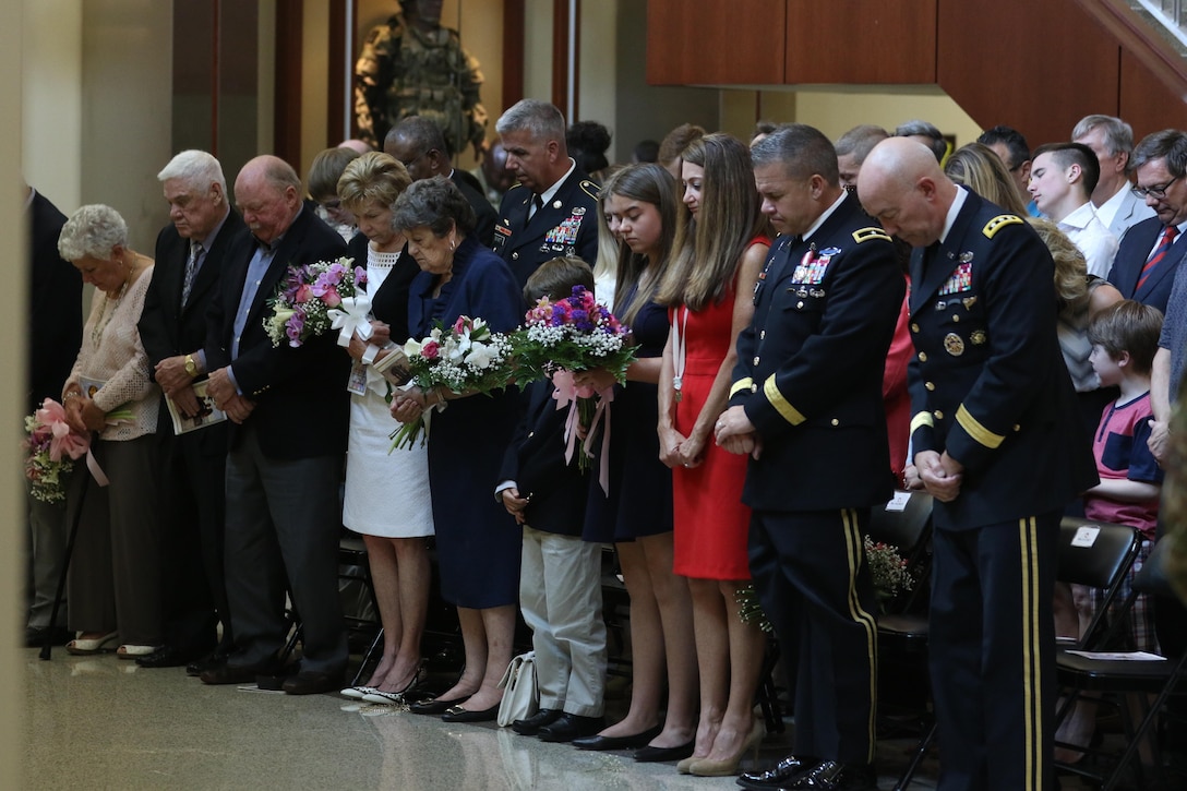 Brig. Gen. Michael Warmack, Chief of Army Reserve Command Operations, Plans and Training, and his family pray during the benediction portion of Warmack’s retirement ceremony at Fort Bragg, N.C., June 29, 2017. LTG Charles D. Luckey, Commanding General, U.S. Army Reserve Command, praised Warmack for his efforts in the ongoing transformation of the Army Reserve into a lethal and ready force. (U.S. Army Reserve photo by Staff Sgt. Felix R. Fimbres)